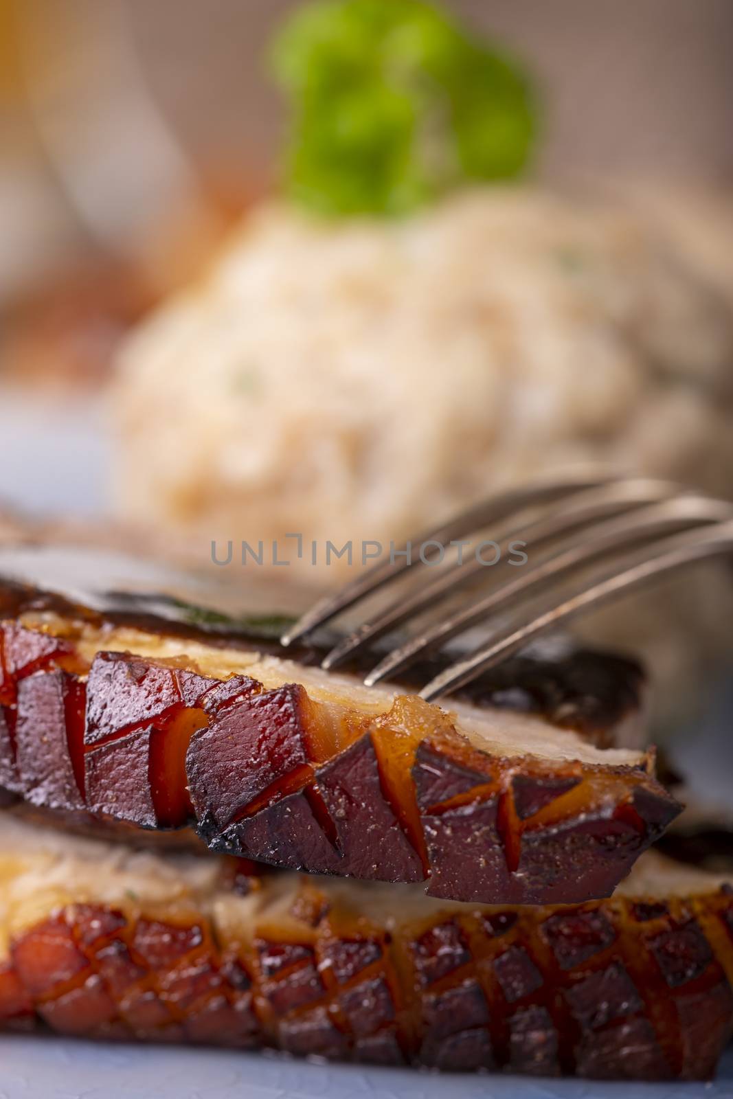 portion of fresh roasted pork on a blue plate