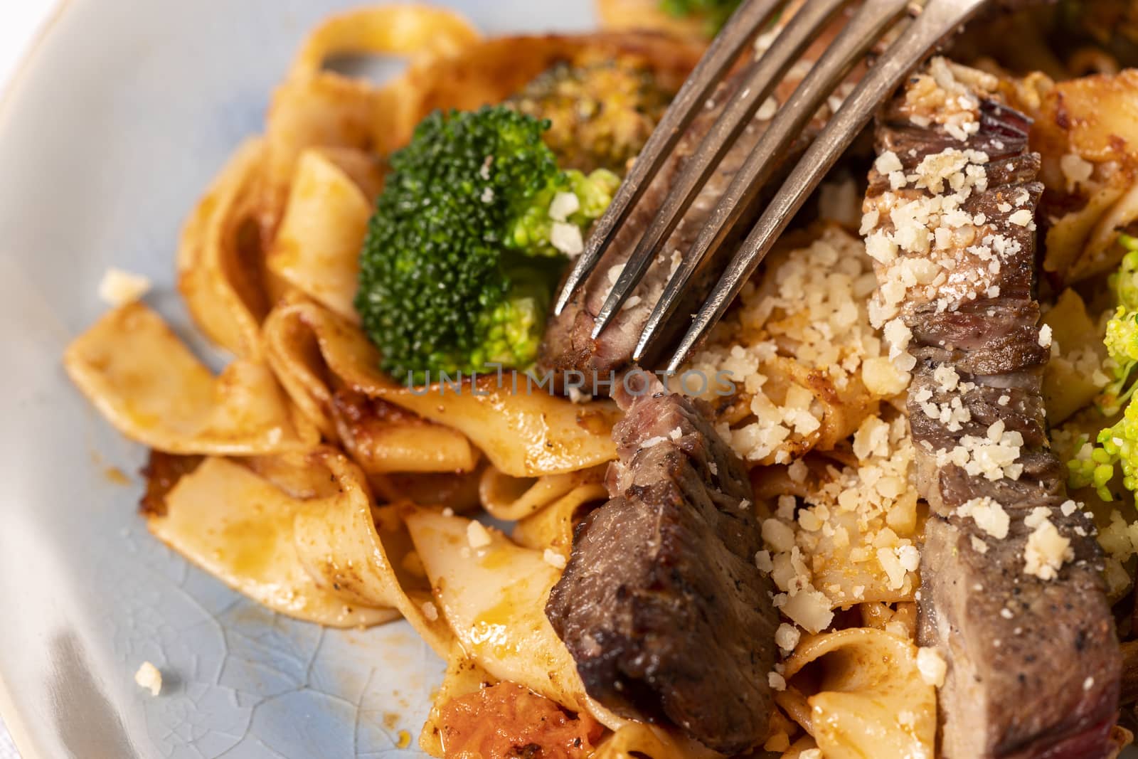 tagliatelli with steak slices on a plate