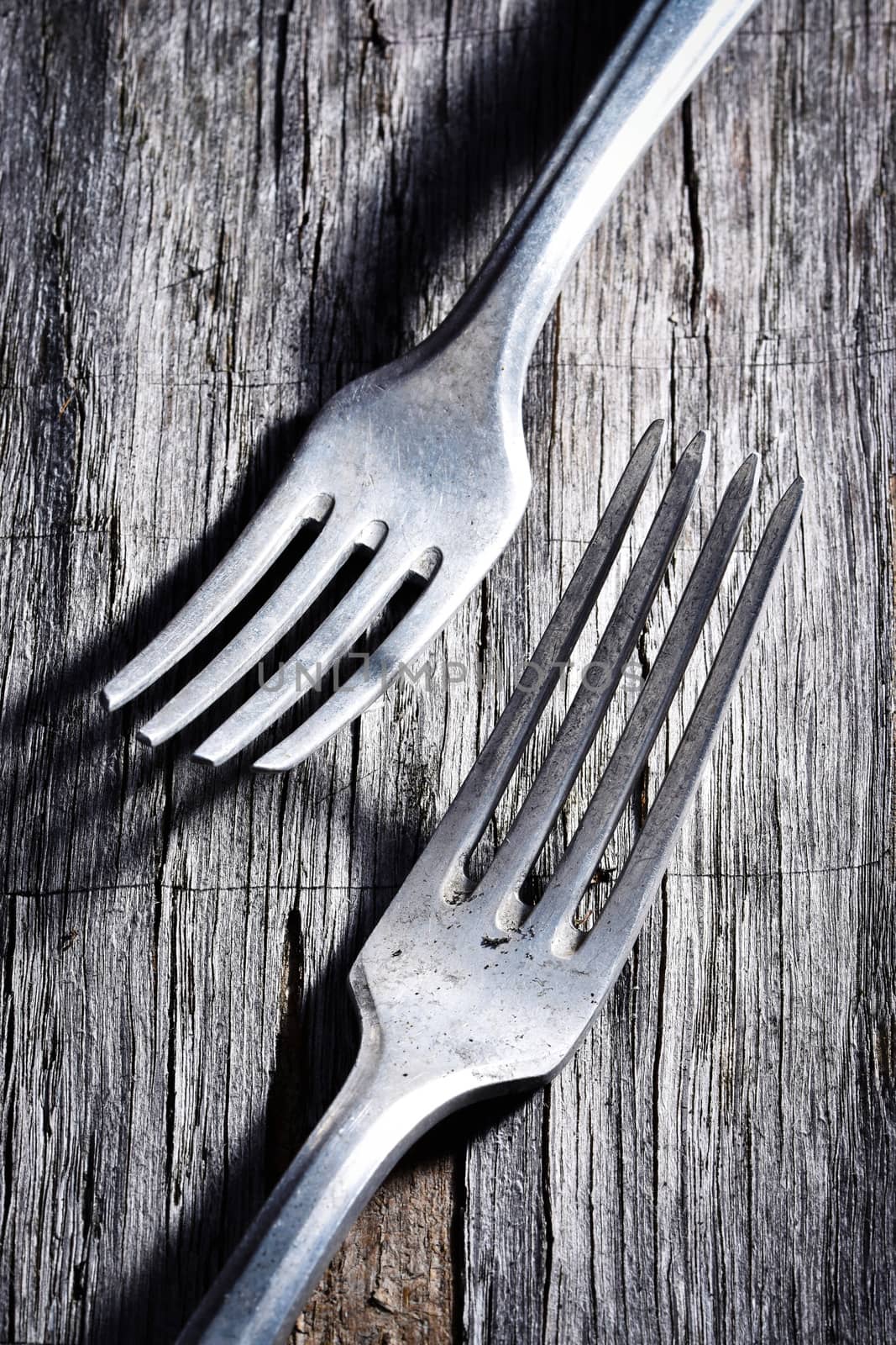 background two old forks on a gray plate