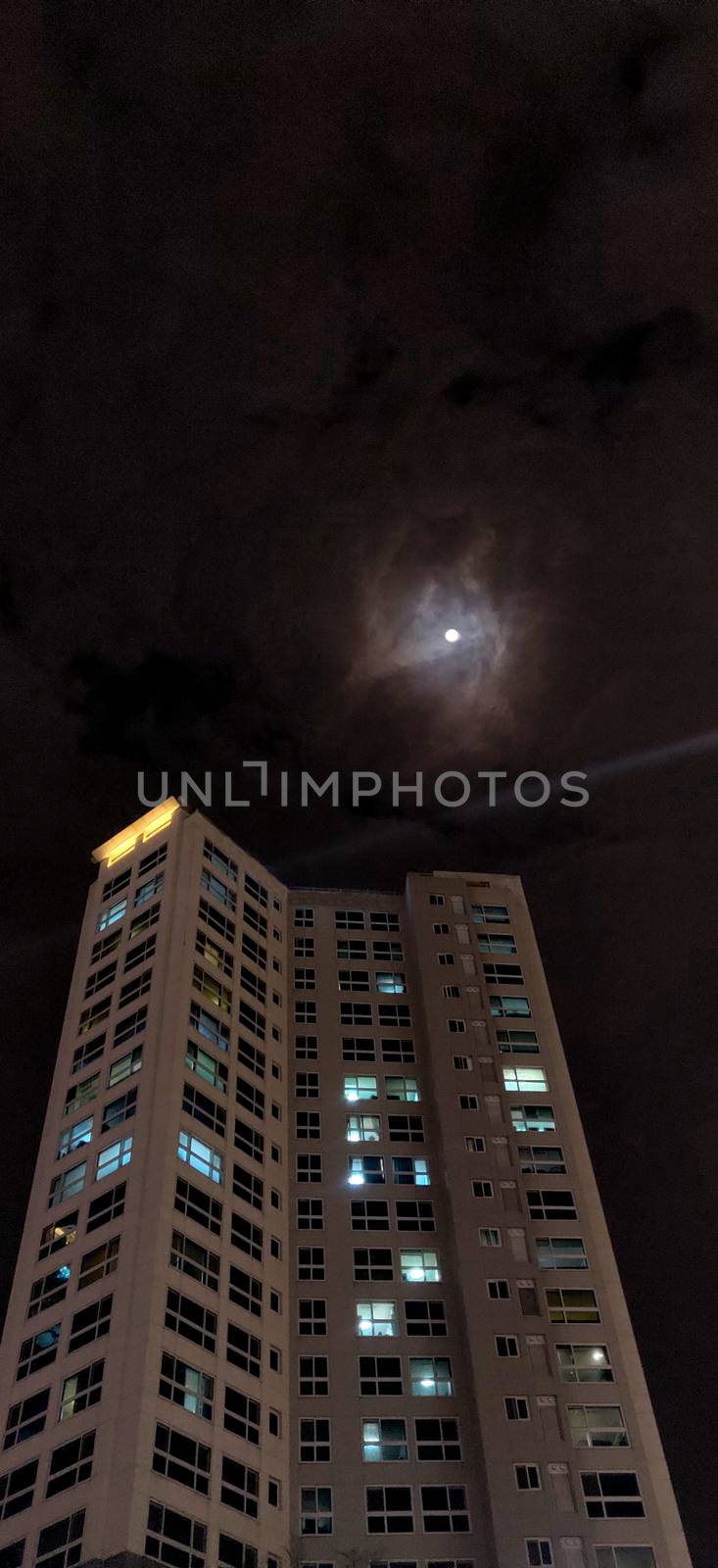 One residential building at night with bright moon by mshivangi92