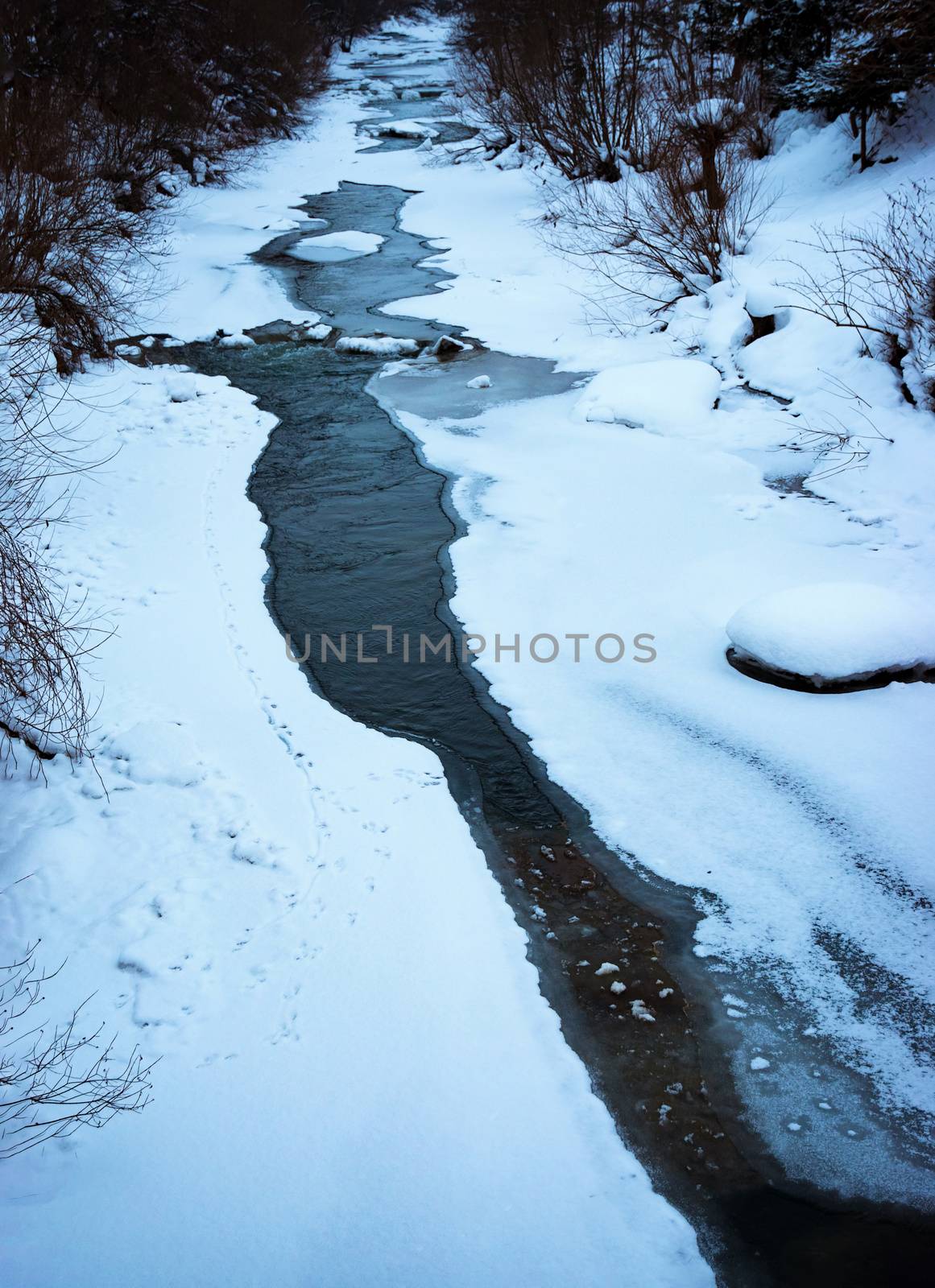 winter thawed line on a frozen river by Ahojdoma