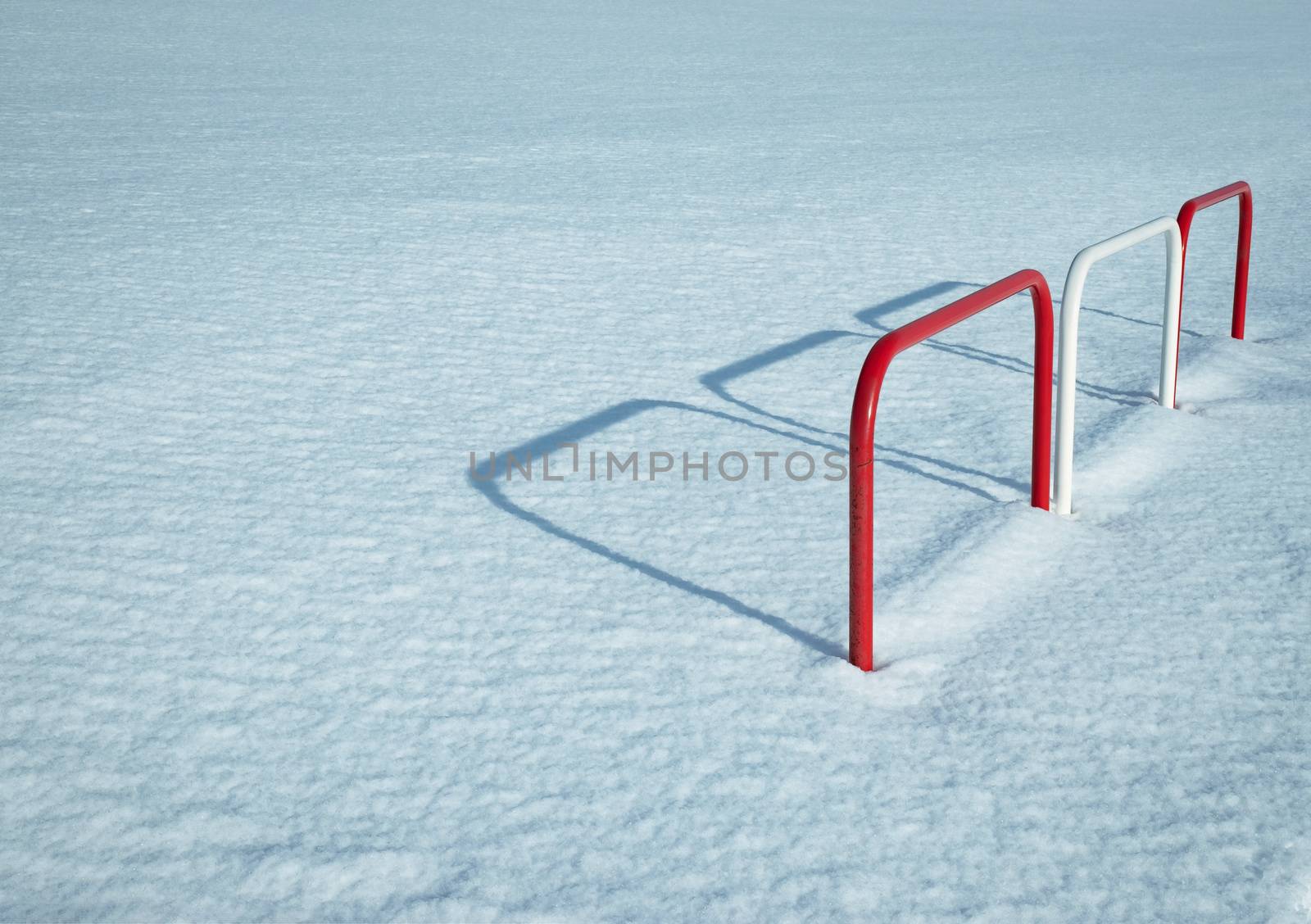 background snowy meadow with a metal fence