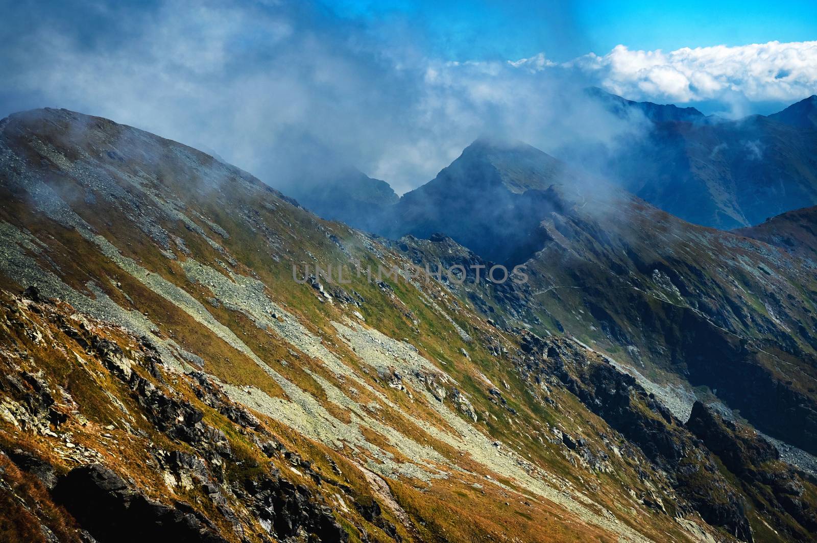 landscape background fog over the ridge of the high mountain