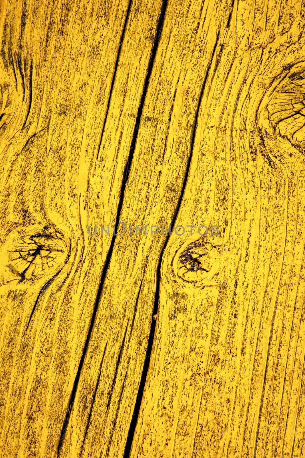 background or texture detail of an old yellow painted wood board