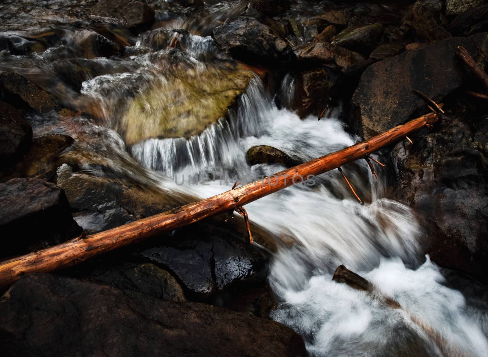 nature background wild brook between rocks