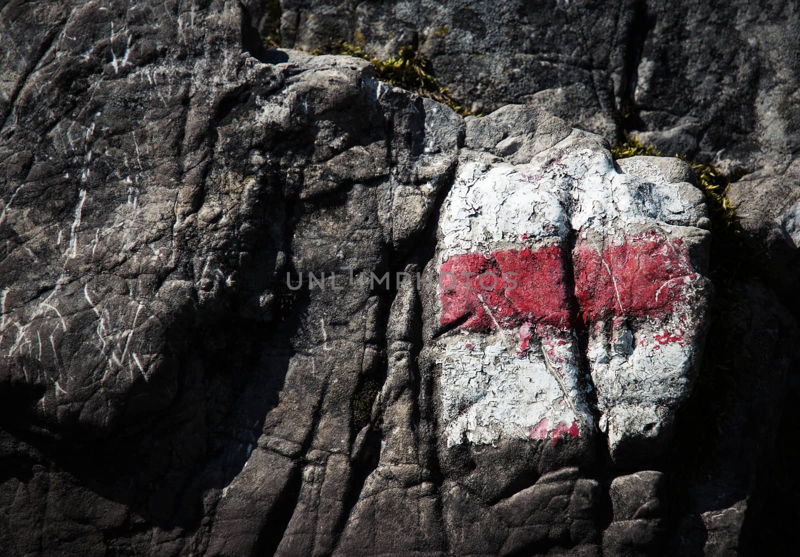 red tourist sign on limestone rock by Ahojdoma