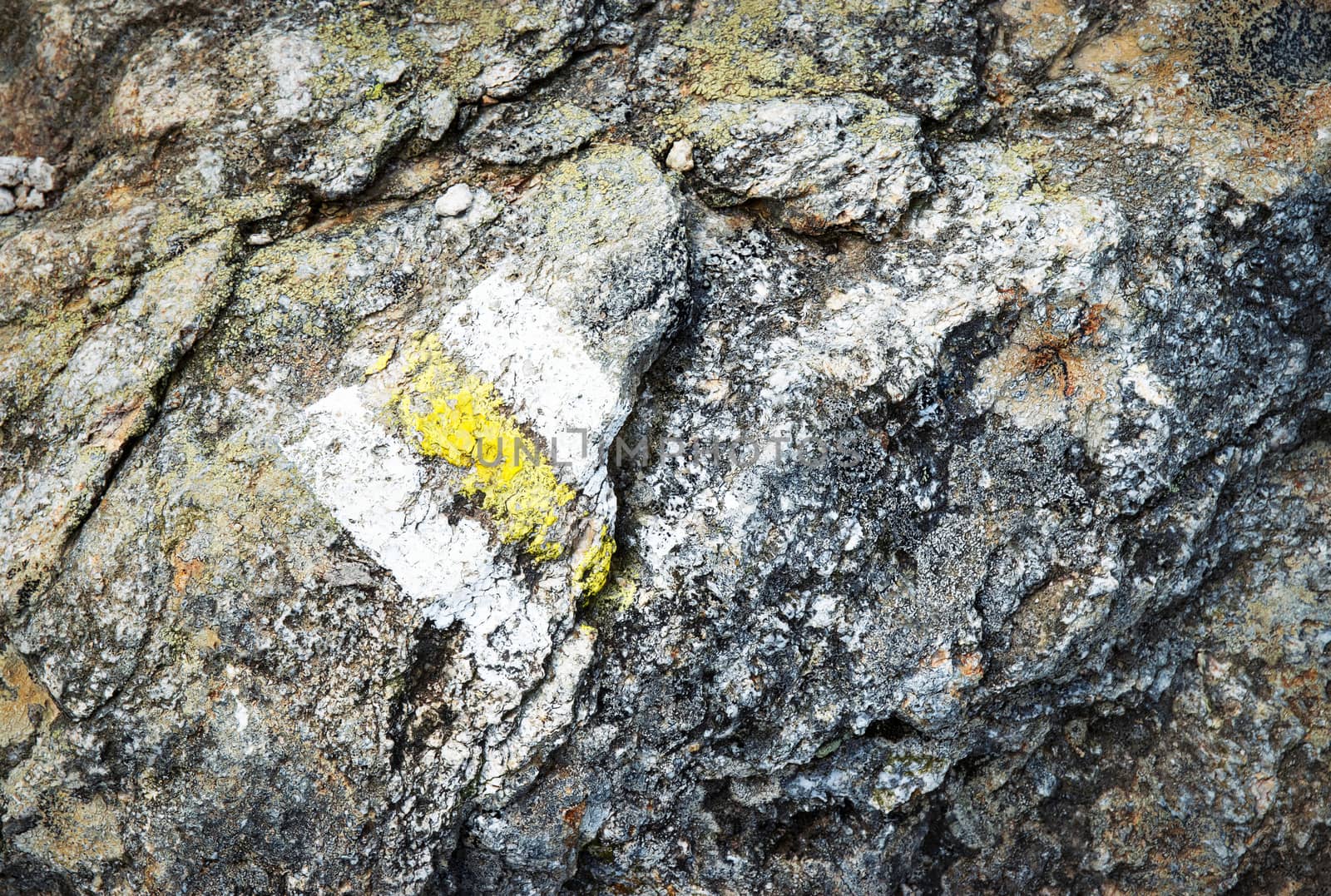 old yellow tourist sign on stone by Ahojdoma