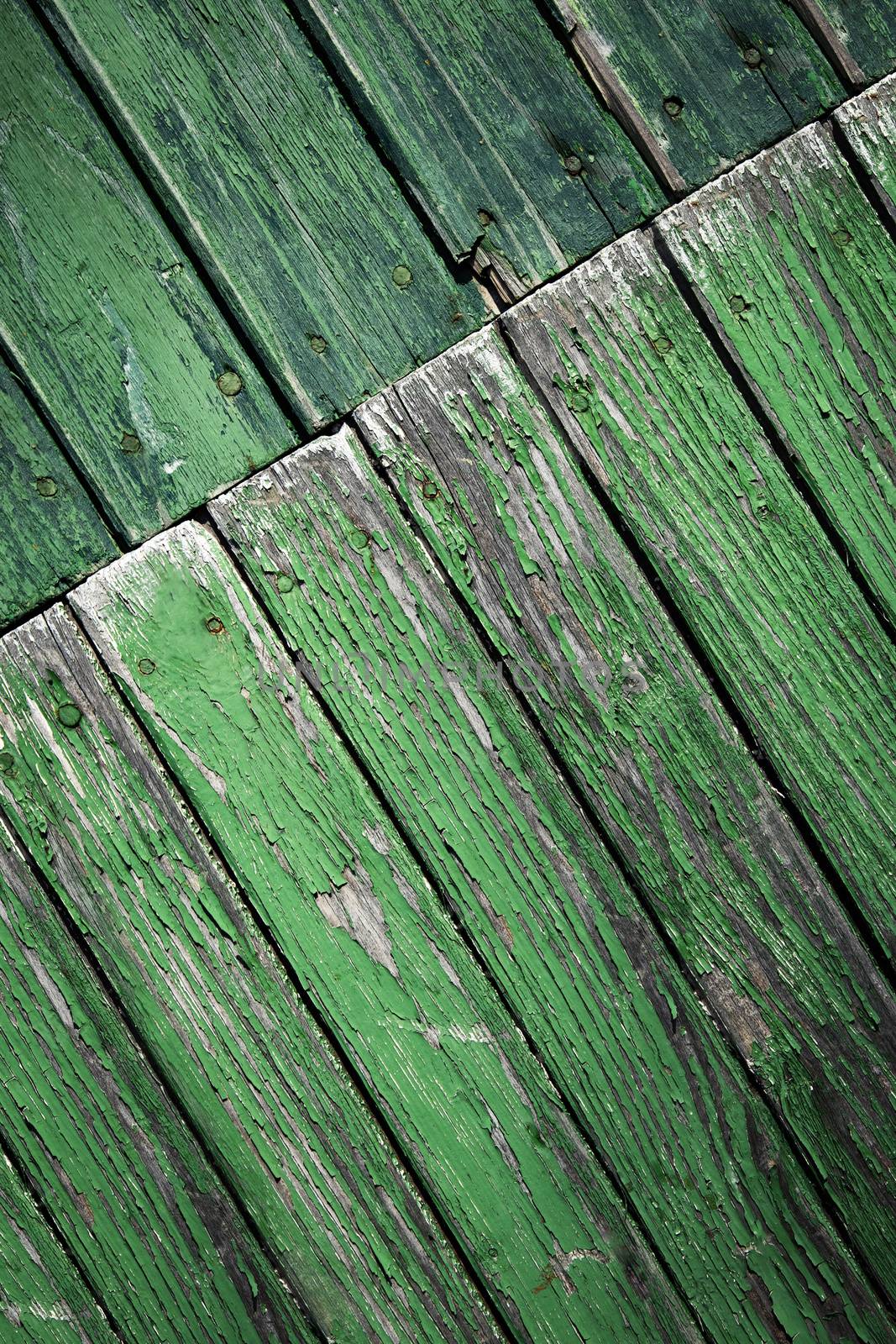 background or texture oblique turned old green wooden paneling
