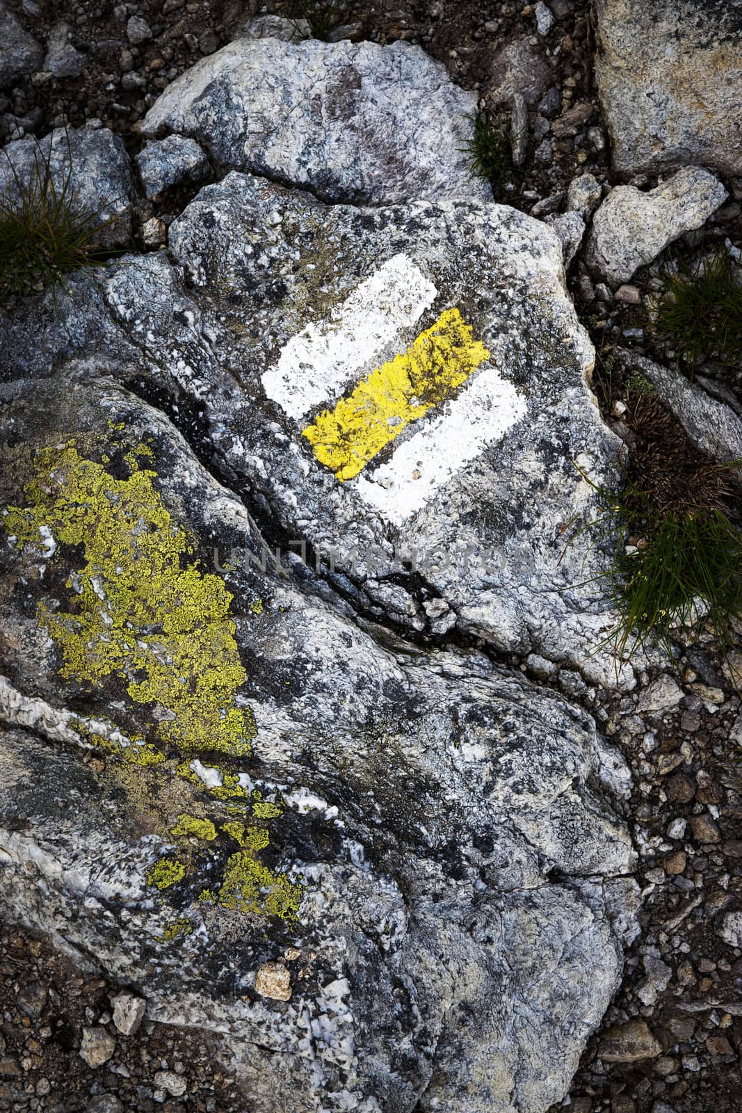 detail background yellow tourist sign on gray stone