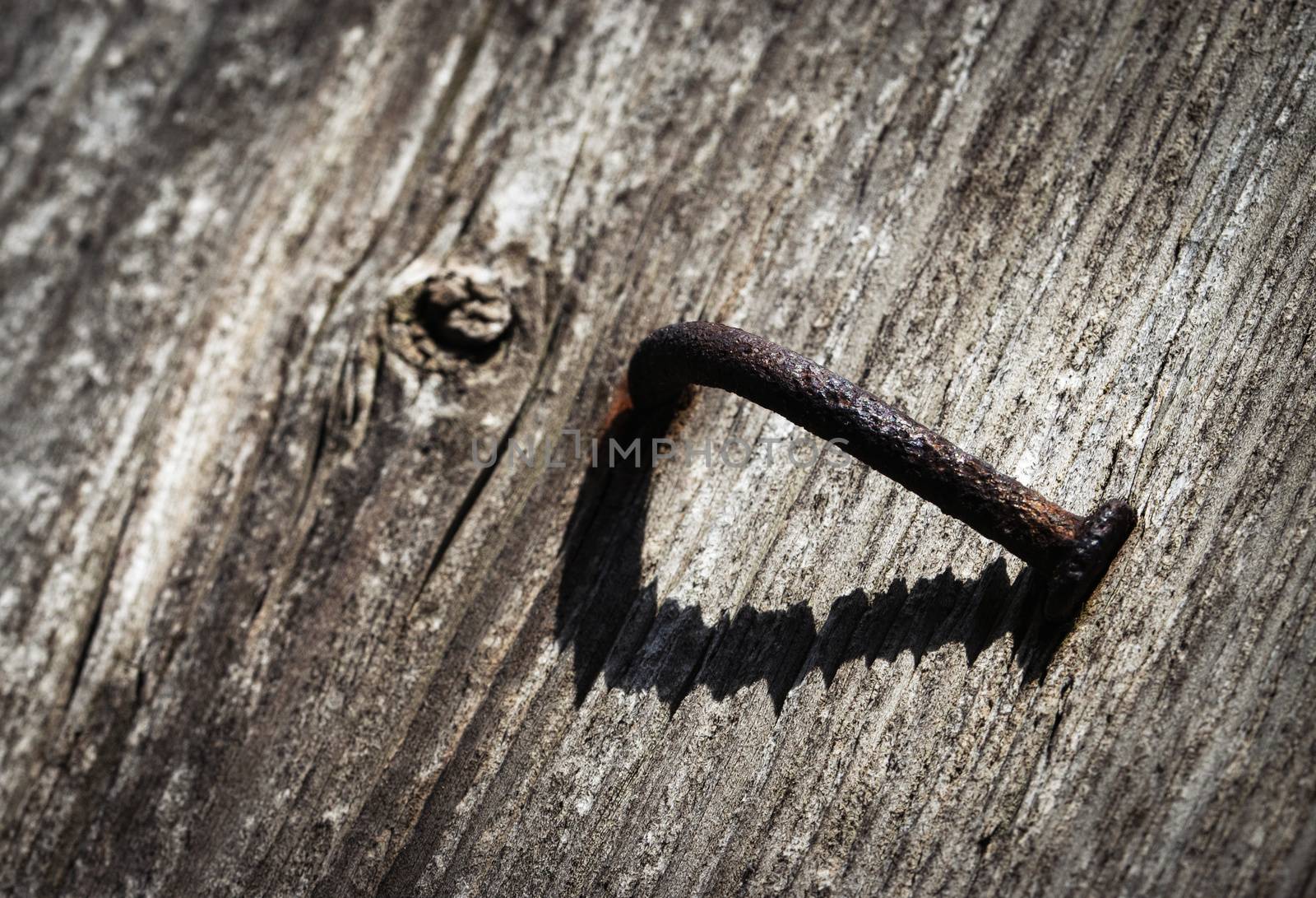 abstract background one bent rusty nail with a shadow