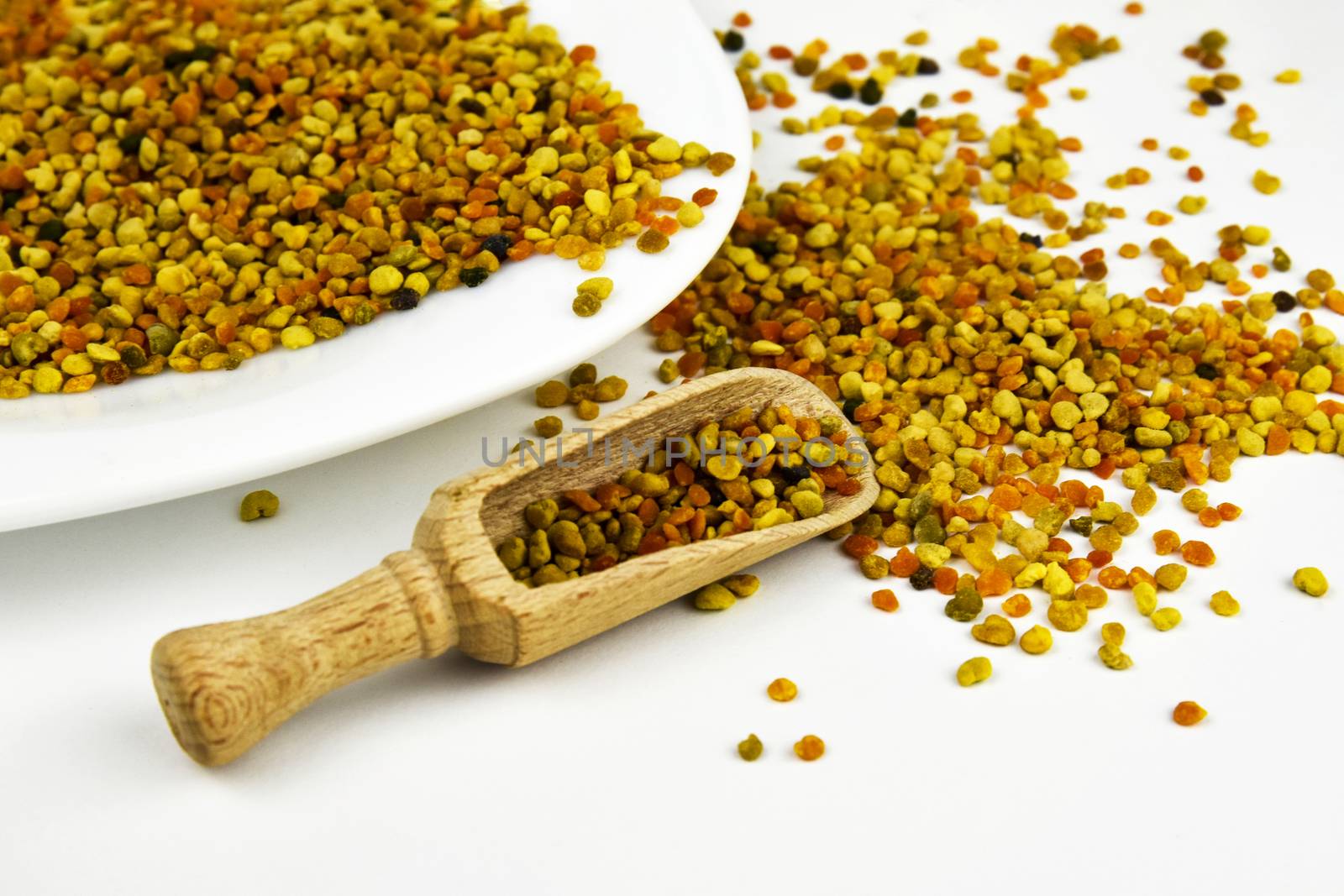 background scattered grains of bee pollen with plate