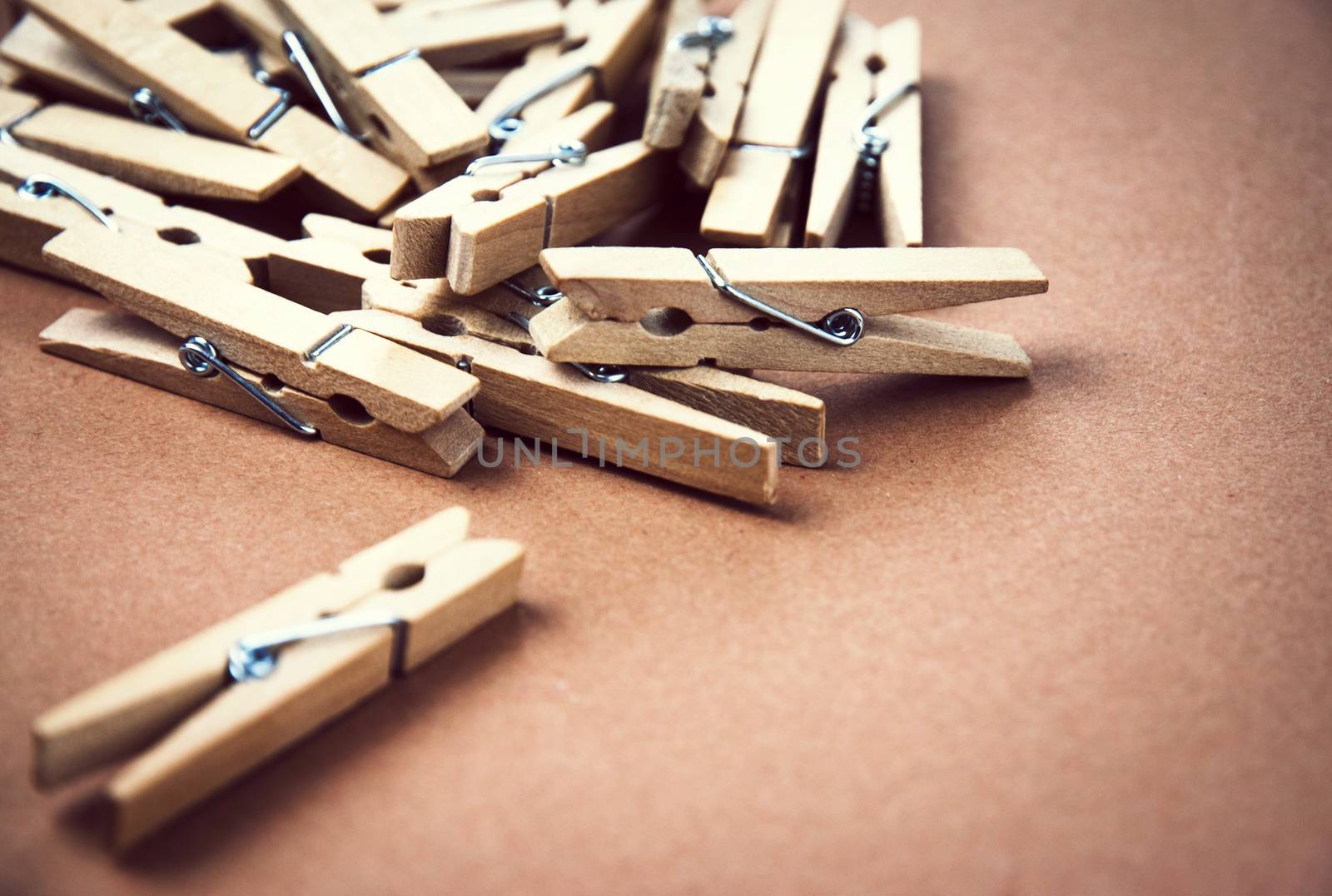 background wooden pegs for clothes on brown paper