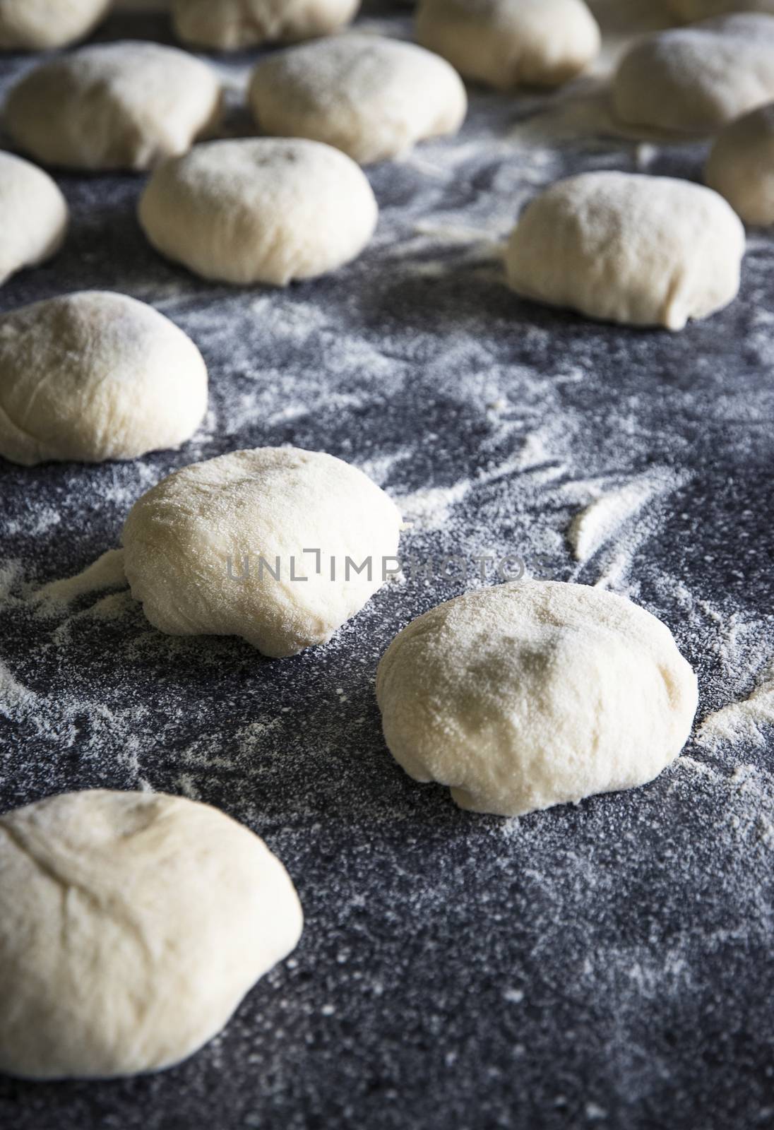 food background buns sprinkled with flour on the table