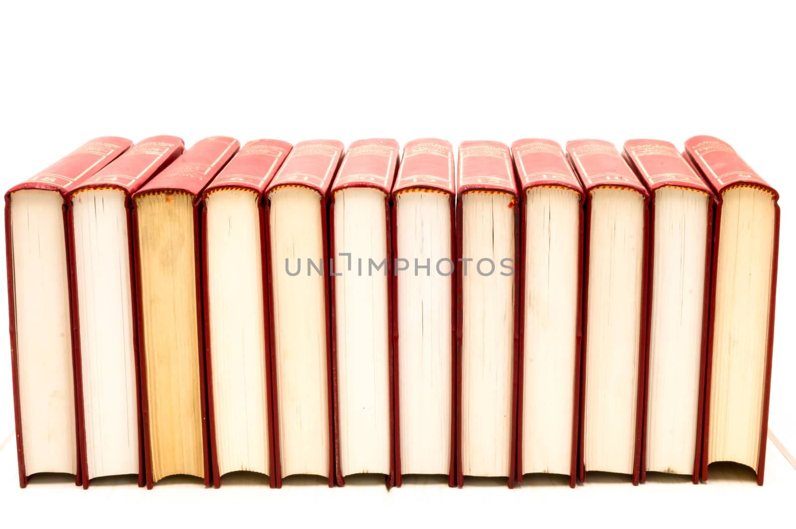 Red books flip over on a floor with white background