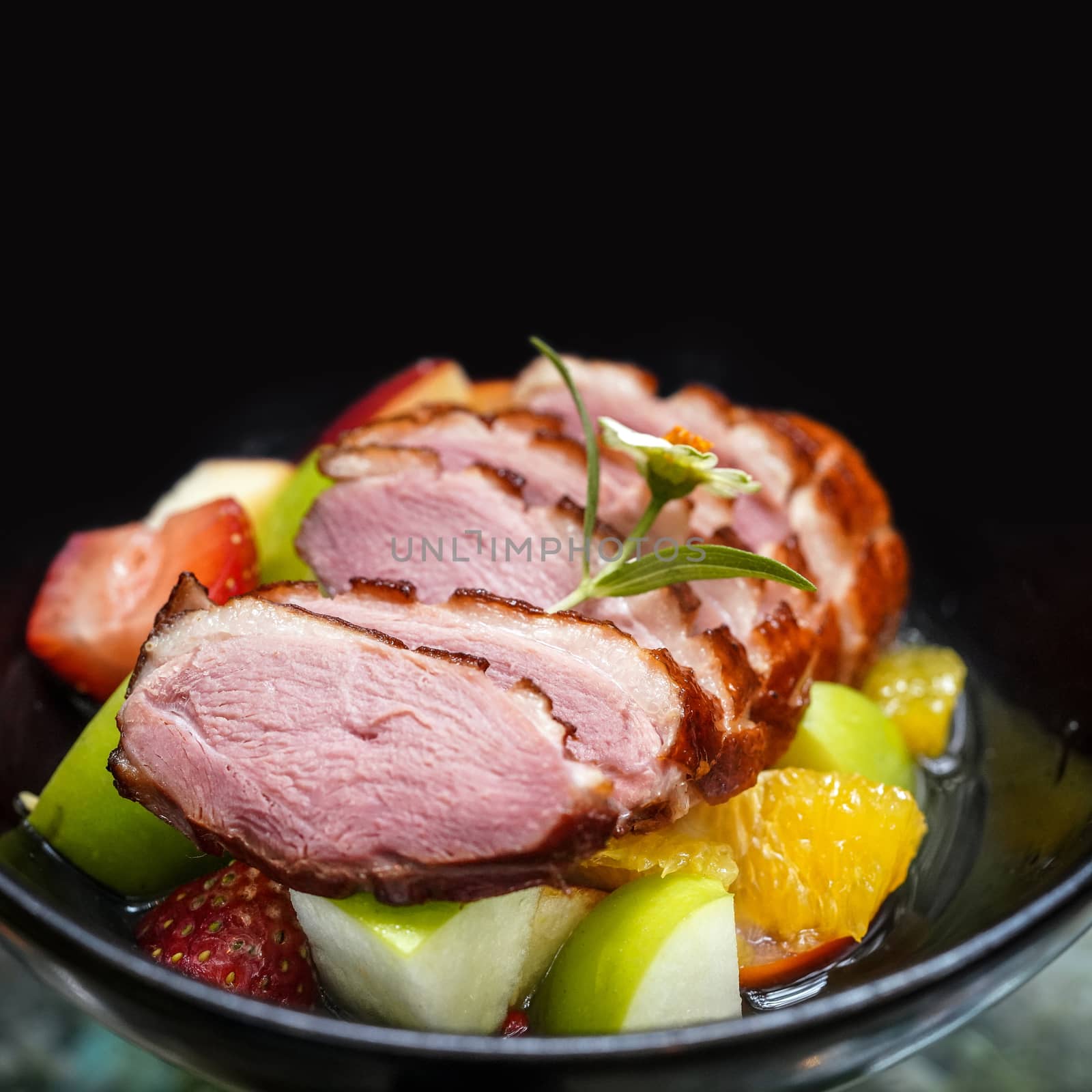 Homemade smoked duck breast served with a variety of fruits. Green Apple, Orange and Strawberry.