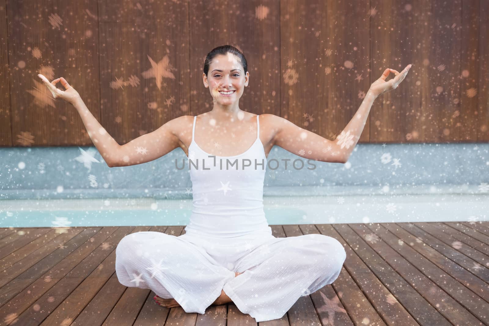 Peaceful happy woman in white sitting in lotus pose against snow