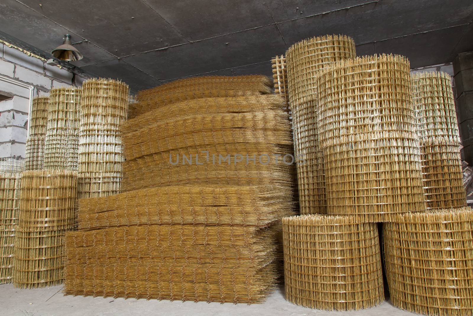 Production of fiberglass mesh reinforcement for construction work.