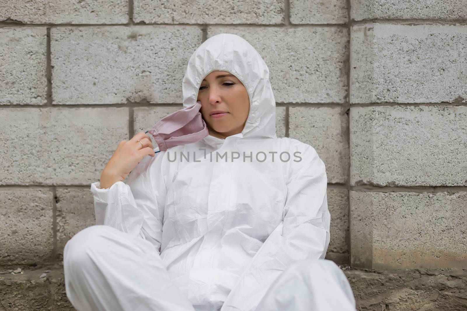 Woman in pink mask and white protective suit outdoors by Angel_a