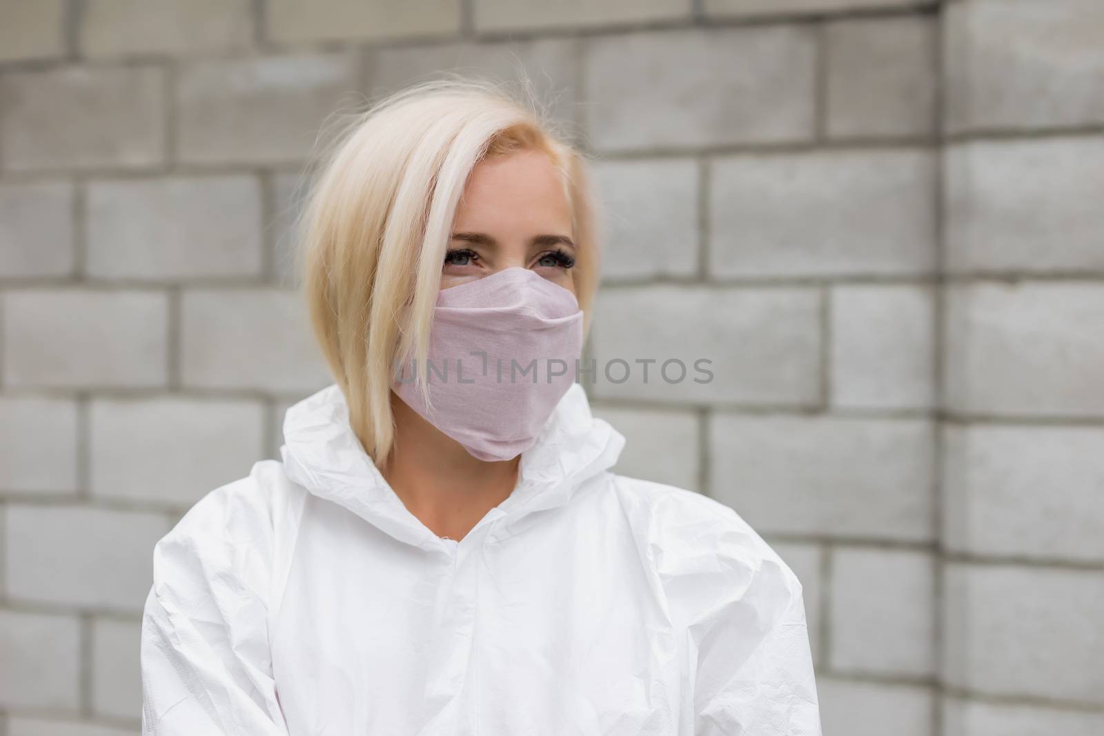 Woman in black mask and white protective suit outdoors by Angel_a