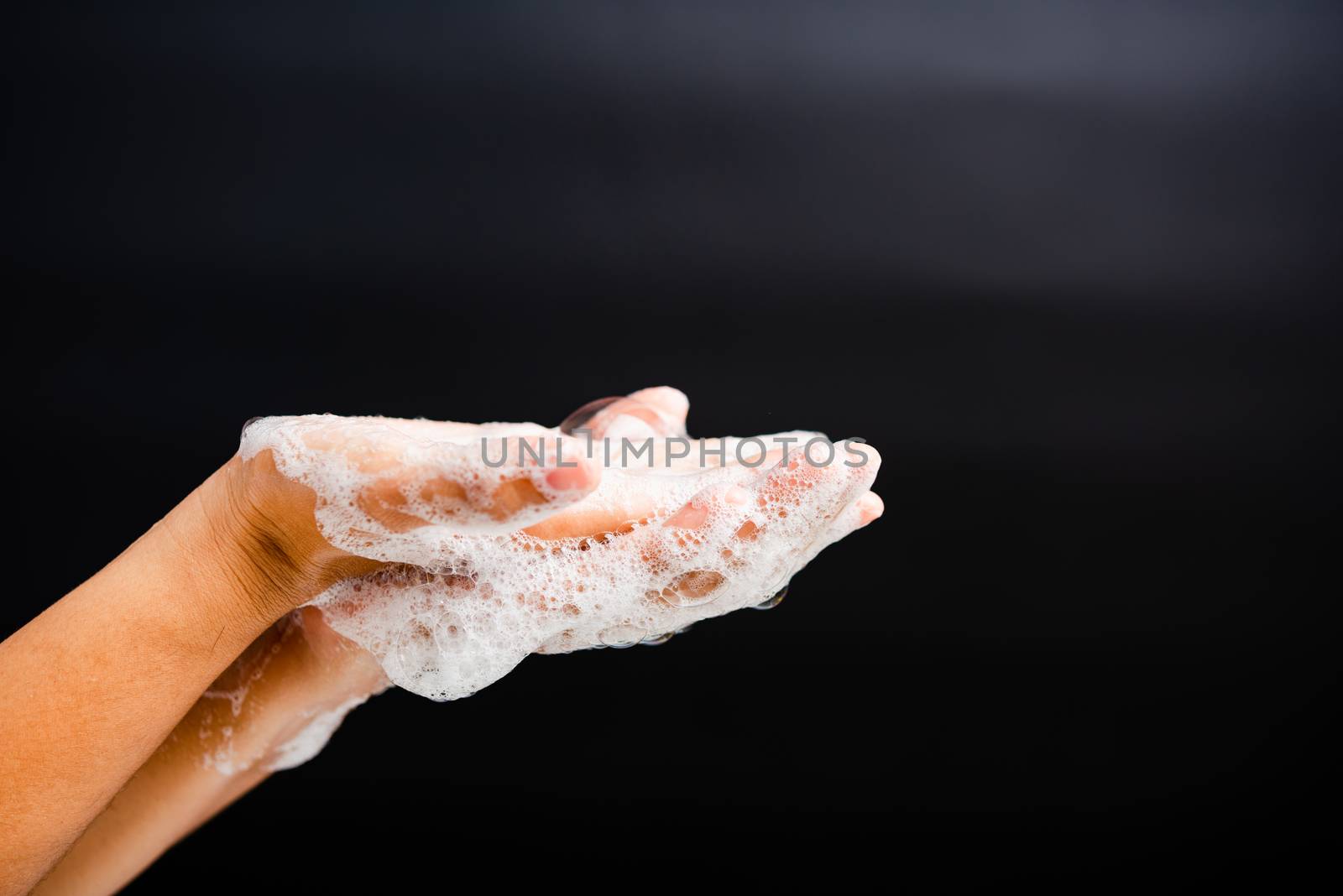Closeup body care Asian young woman washing hands with soap have foam, hygiene prevention COVID-19 or coronavirus protection concept, isolated on black background