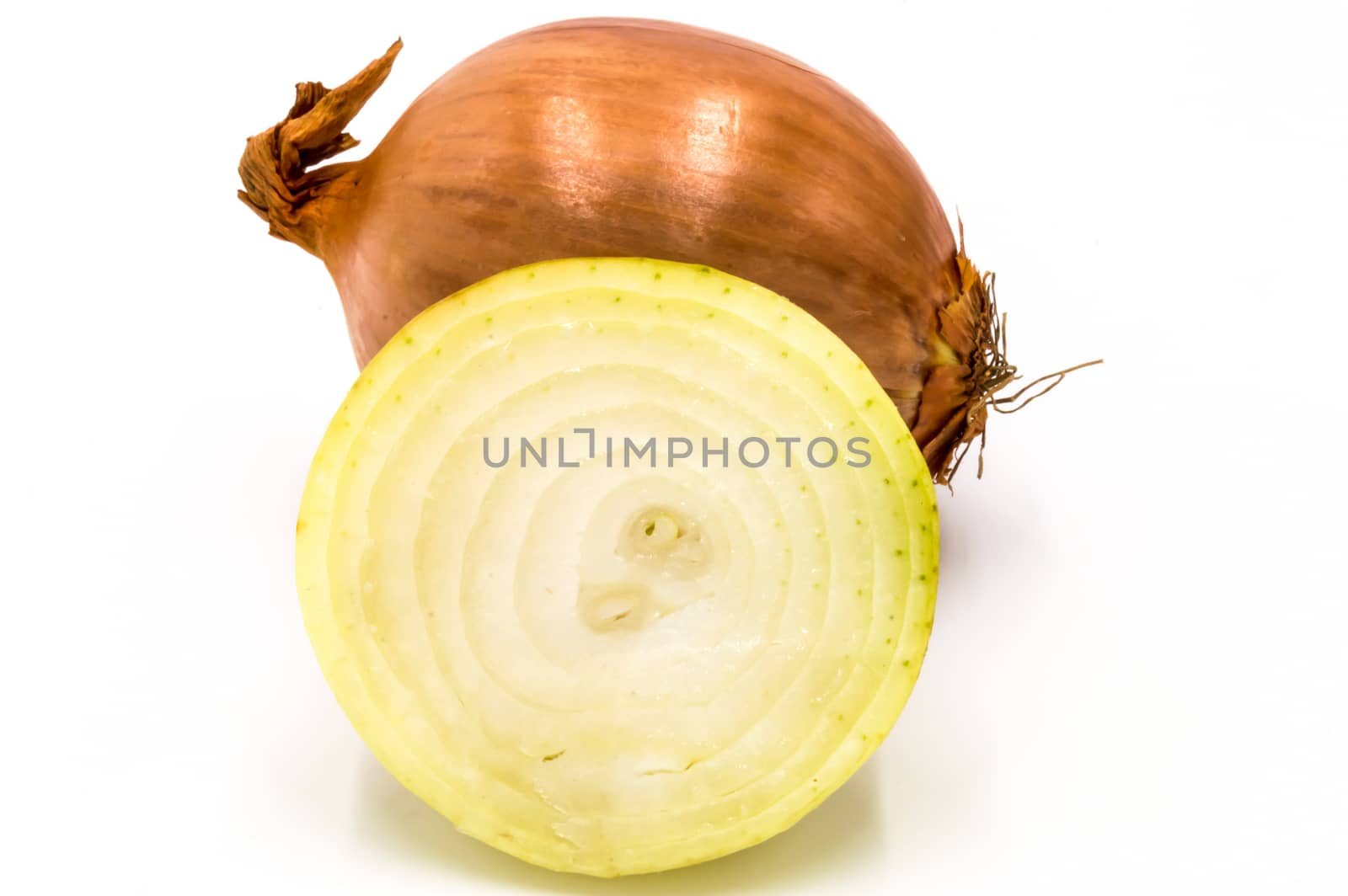 Fresh yellow onion cut in half and whole isolated on white background