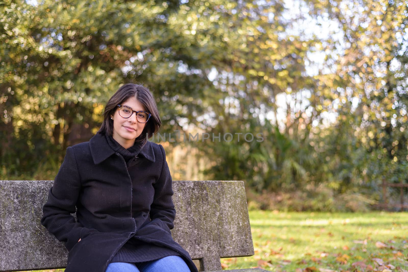 girl with dark hair in a park by brambillasimone