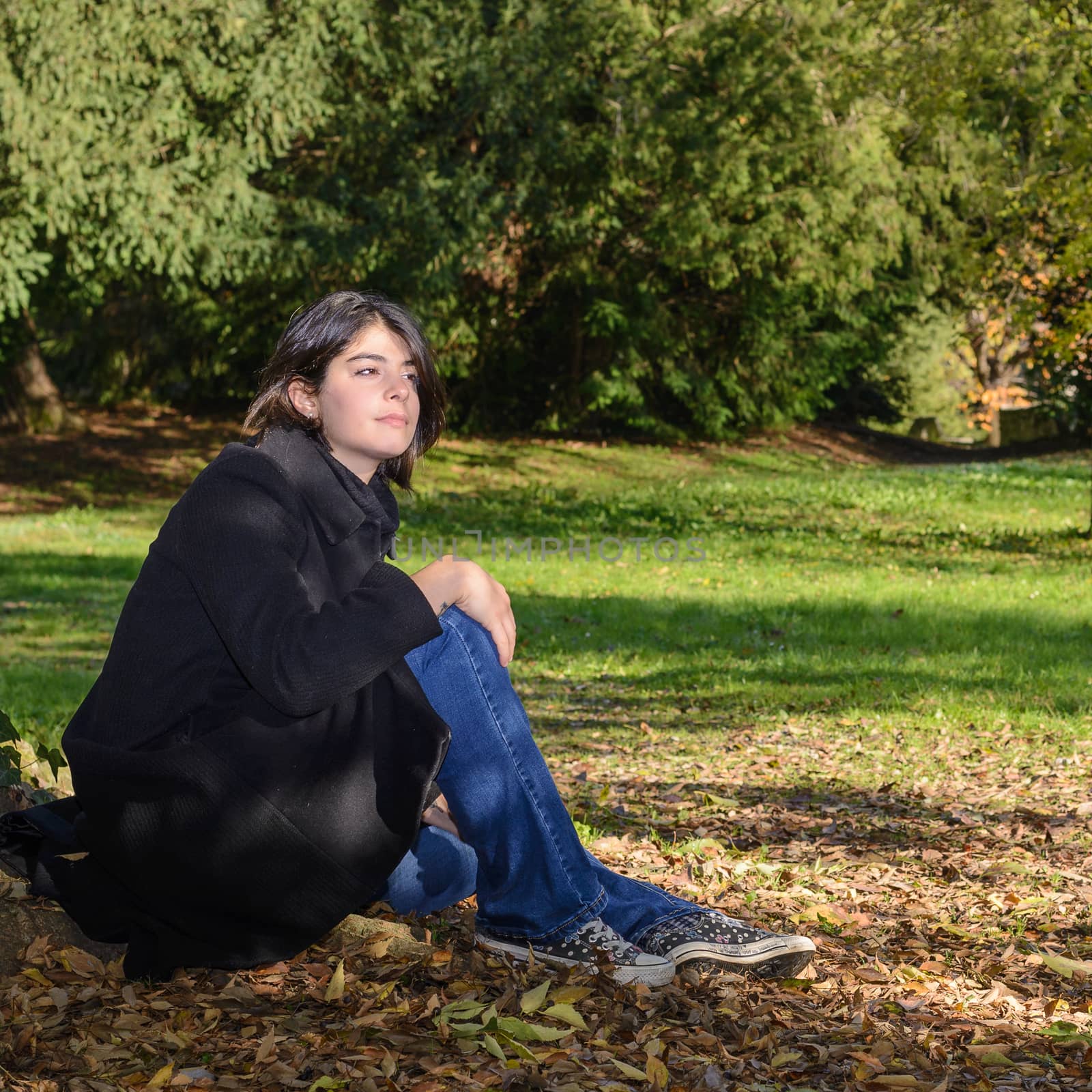 girl with dark hair in a park by brambillasimone