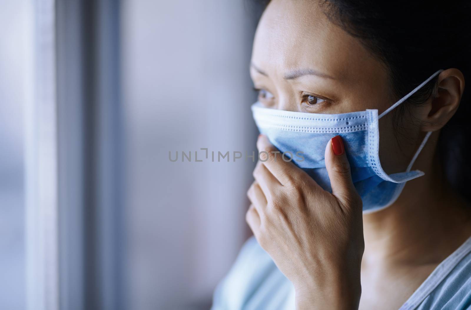 Woman staying at home wearing protective surgical mask by Novic