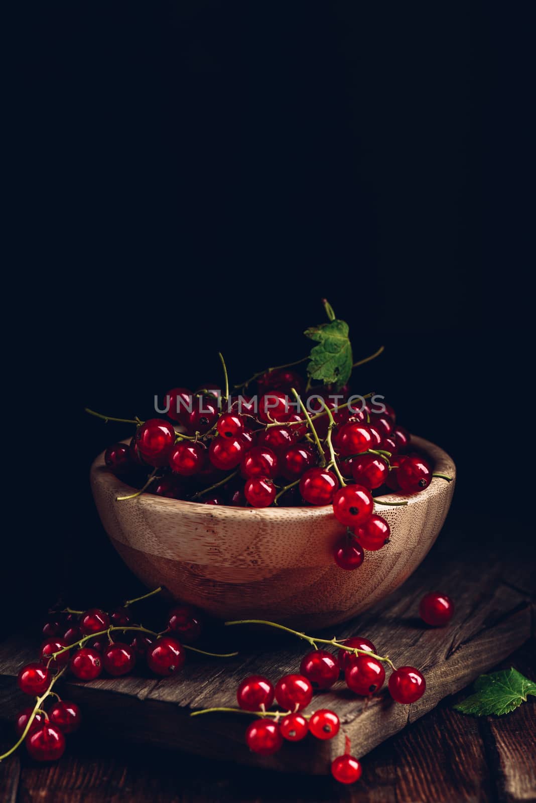 Fresh picked red currants in wooden bowl