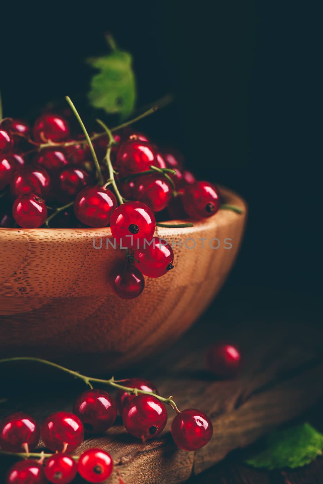 Fresh picked red currants in wooden bowl