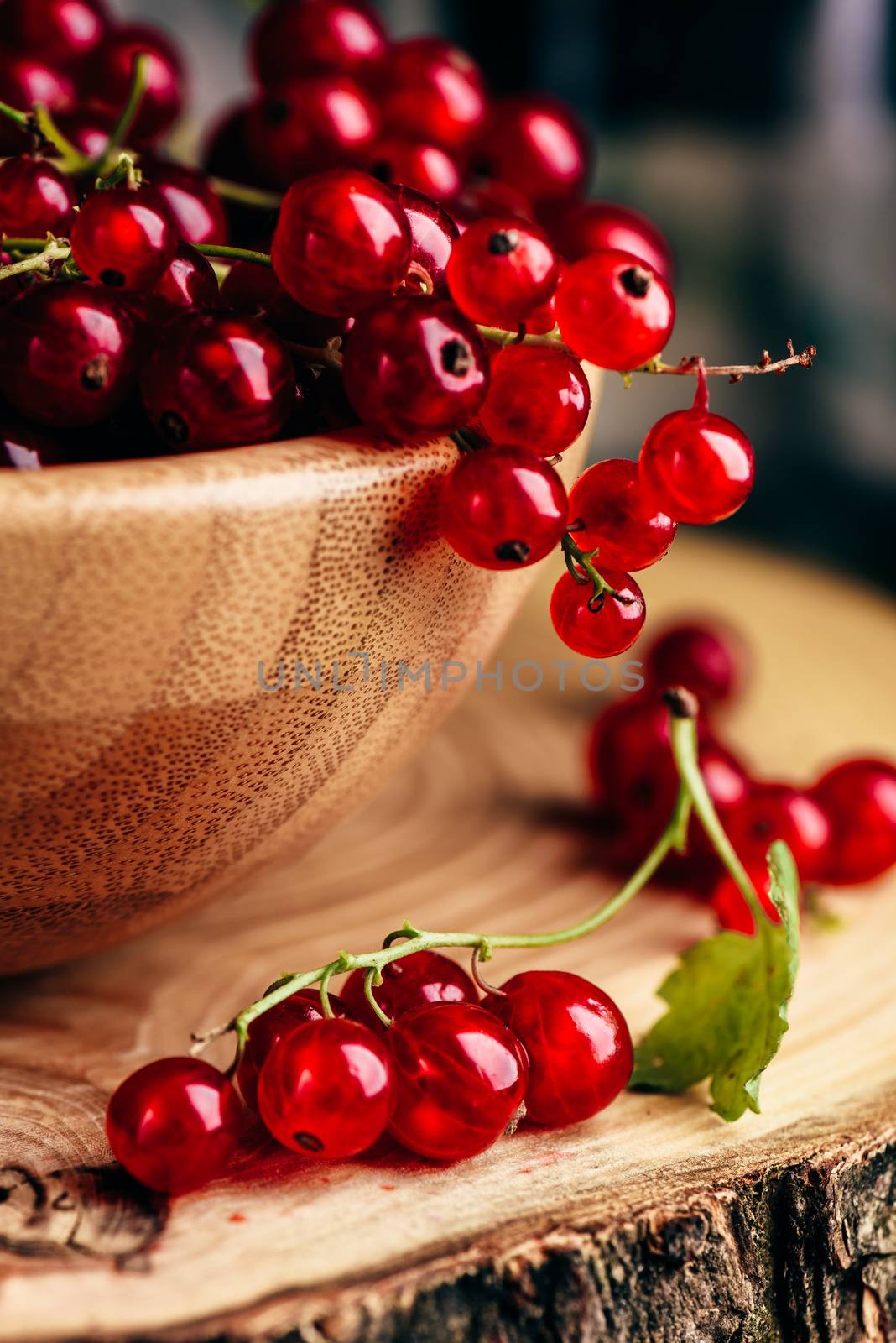 Fresh picked red currants in wooden bowl