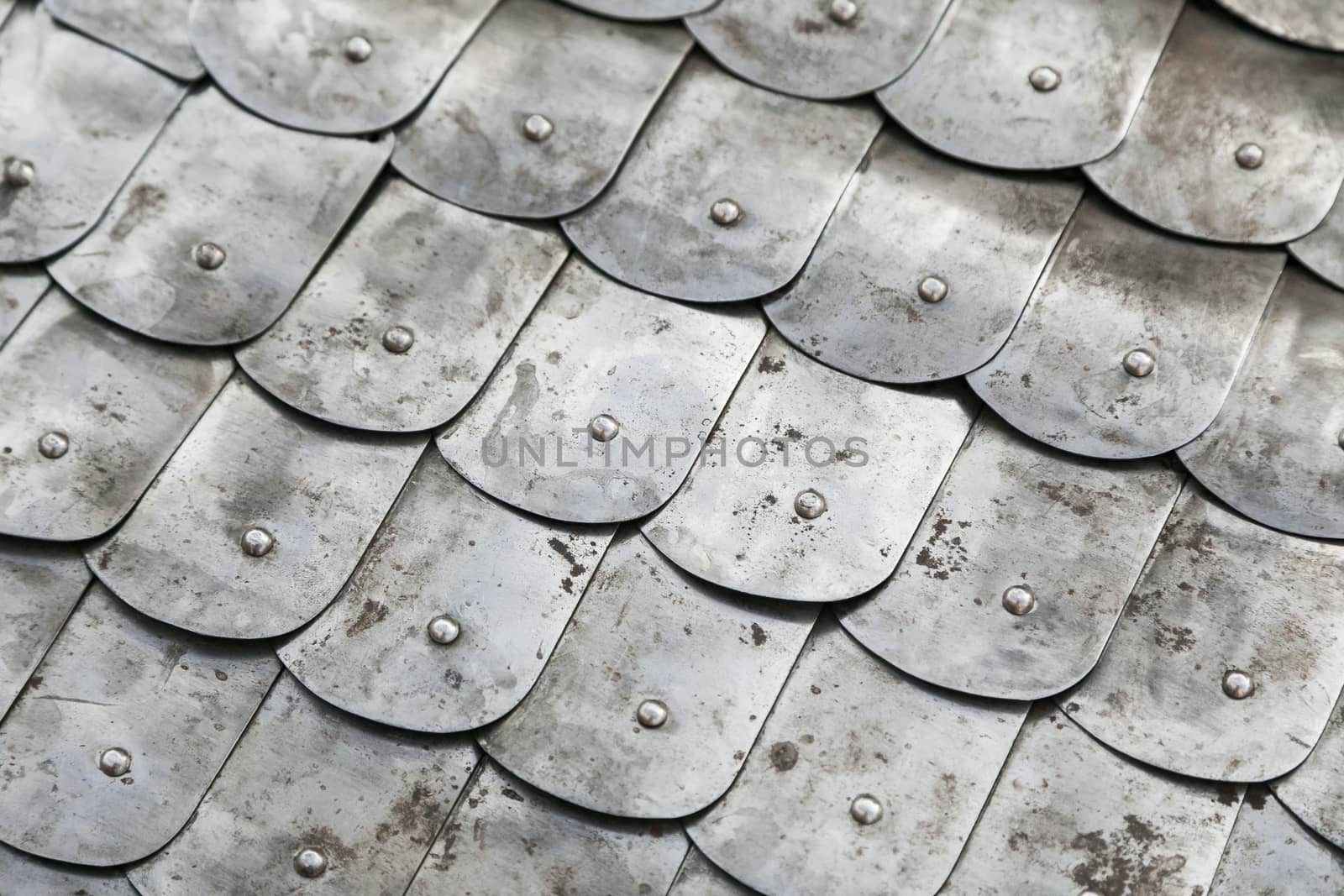 Fragment of a knightly metal chain mail of scales. Background metal chain mail.