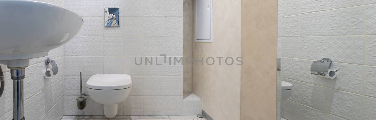 Interior of a modern bathroom with a sink and toilet by bonilook