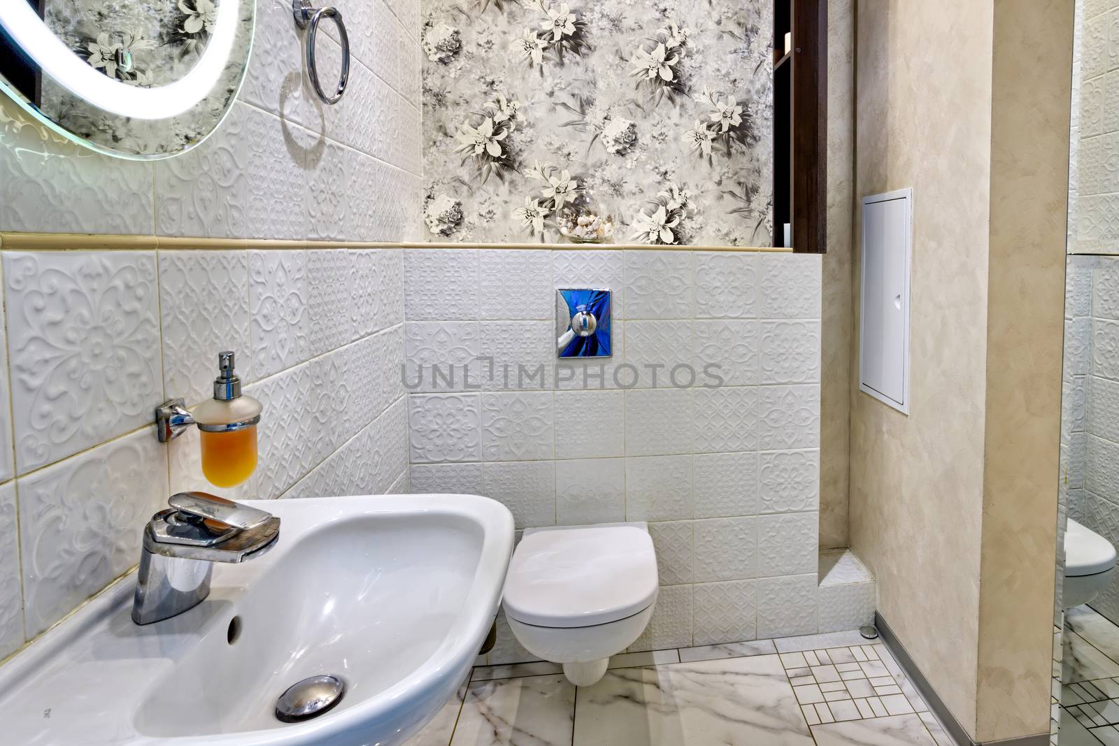 Interior of a modern bathroom with a sink and toilet by bonilook