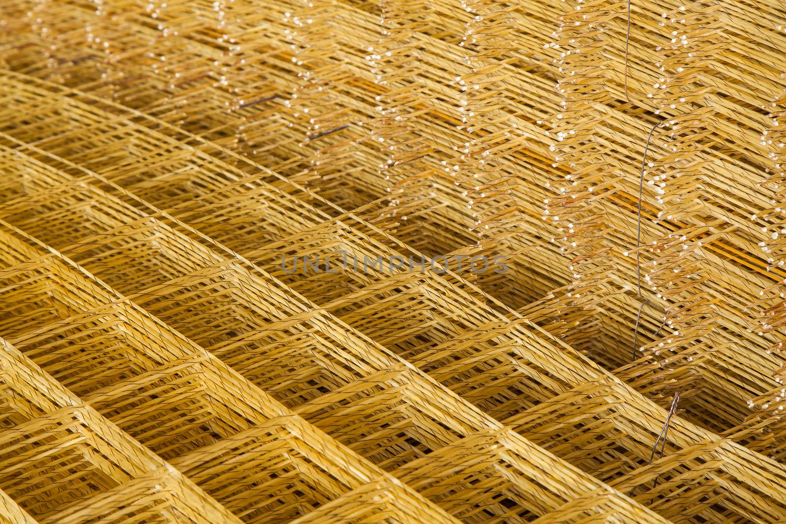 Production of fiberglass mesh reinforcement for construction work.