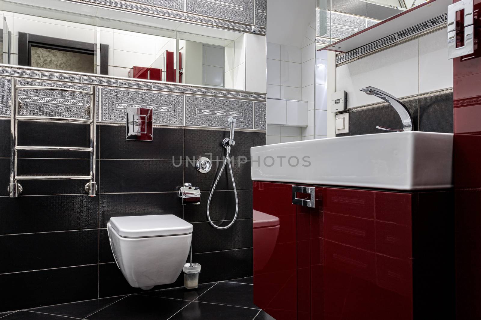 Interior of a modern bathroom with a sink and toilet by bonilook