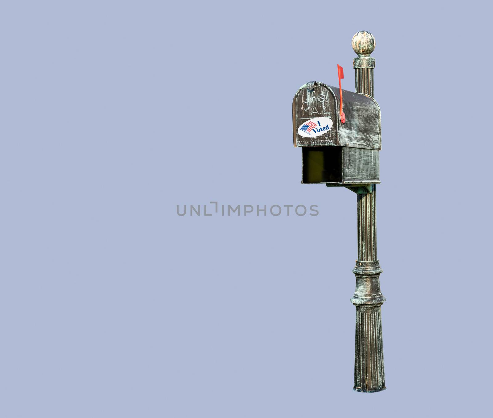 Metal mailbox for rural homes with I Voted sticker as concept for voting by mail or absentee ballot paper on blue background