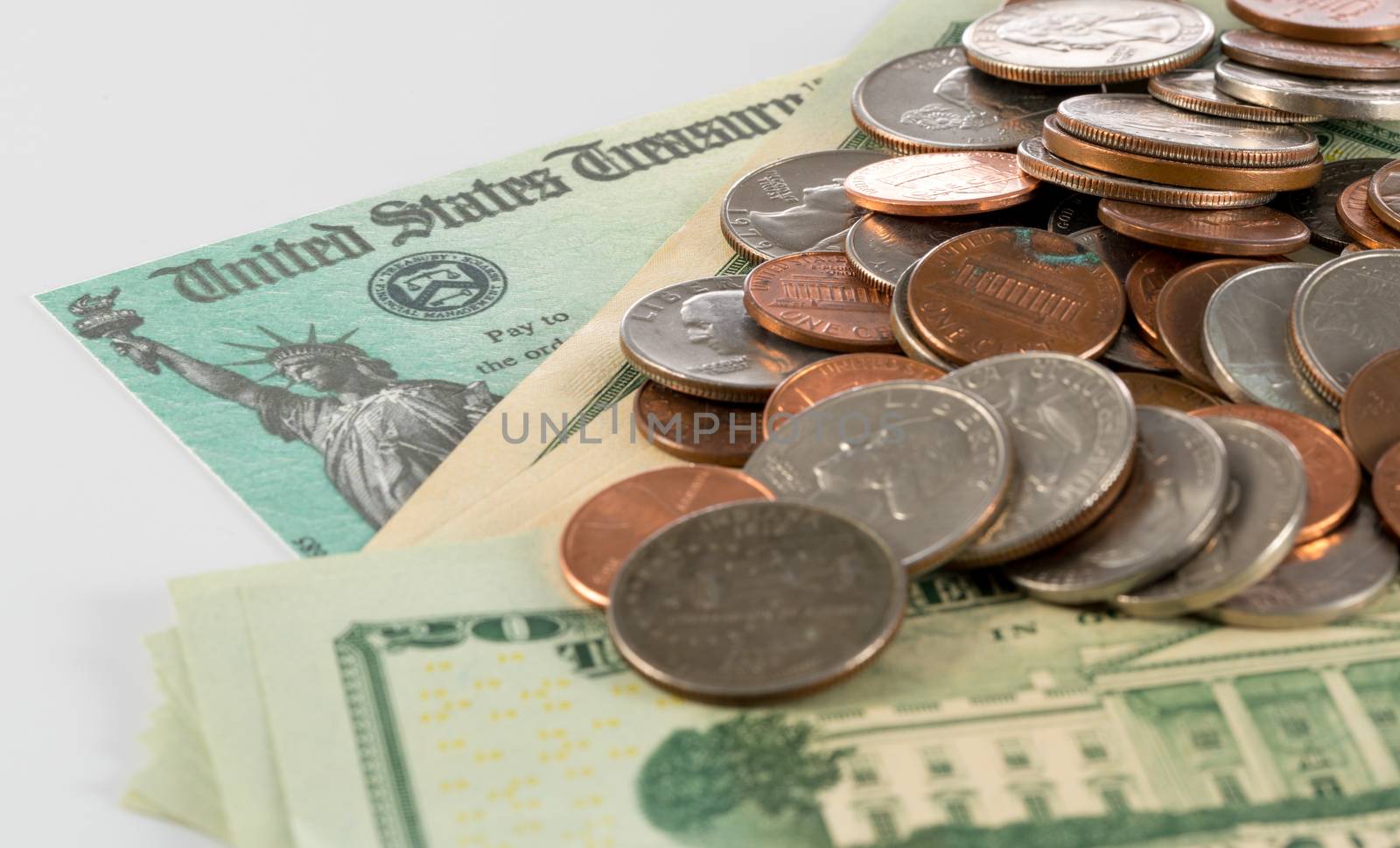 Stack of 20 dollar bills and loose coins with illustrative coronavirus stimulus payment on white