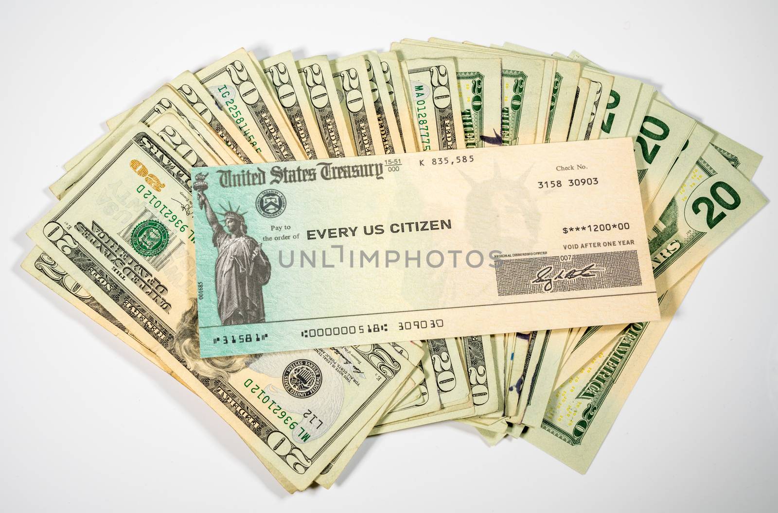 Stack of 20 dollar bills with US Treasure illustrative check to illustrate coronavirus stimulus payment on white background