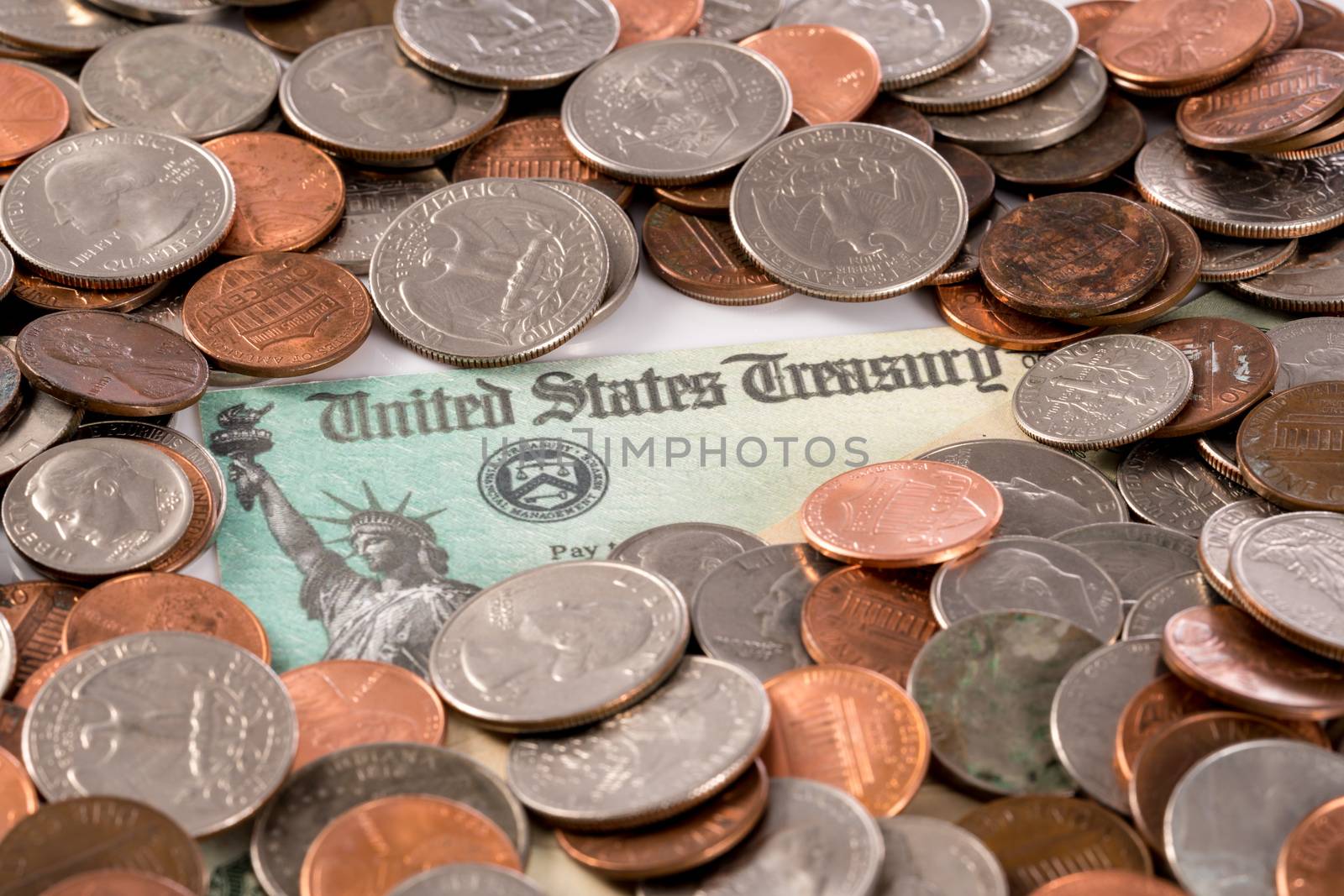 Stack of loose change and coins with illustrative coronavirus stimulus payment to each citizen