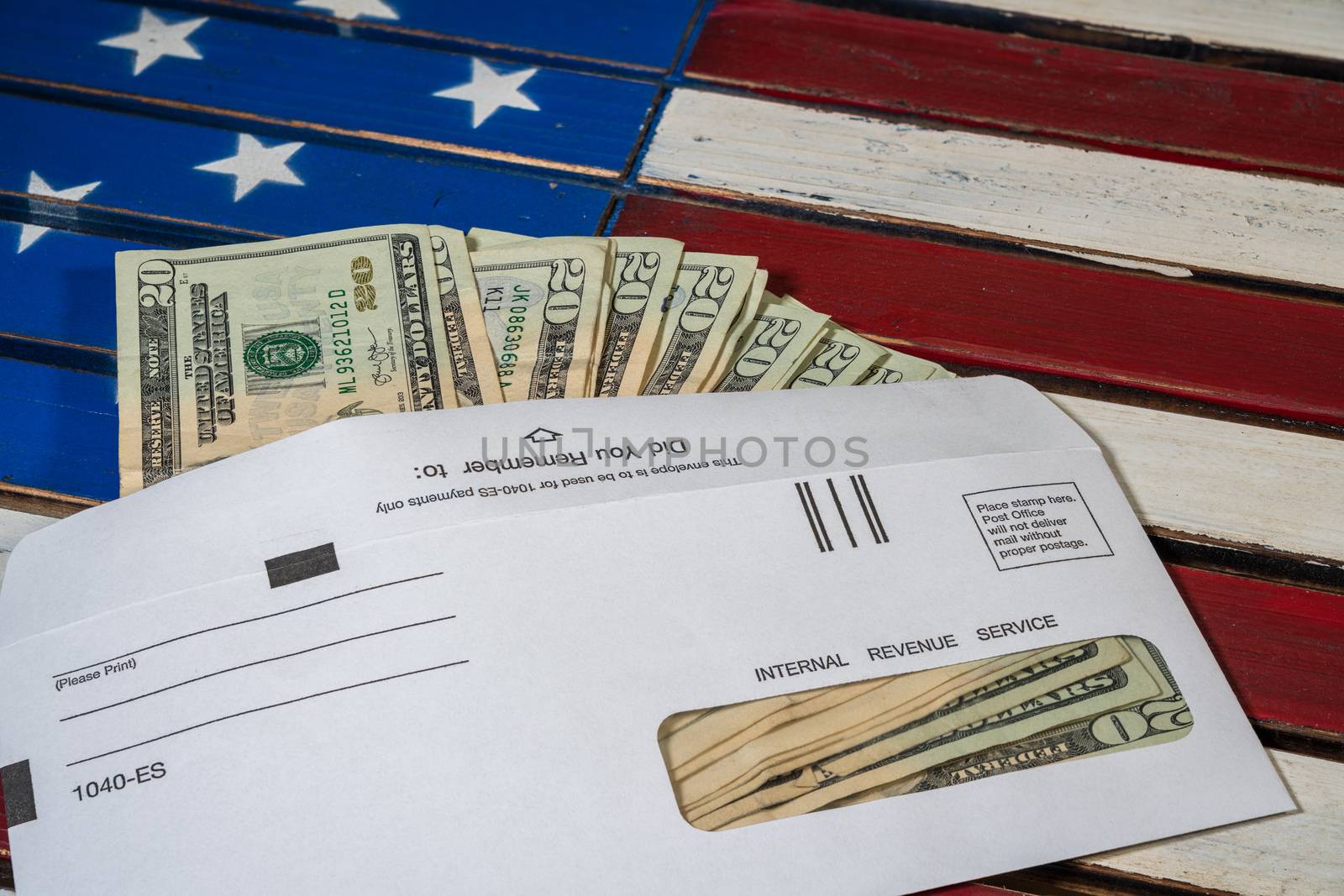 Stack of 20 dollar bills in IRS envelope to illustrate coronavirus stimulus payment or estimated tax payments