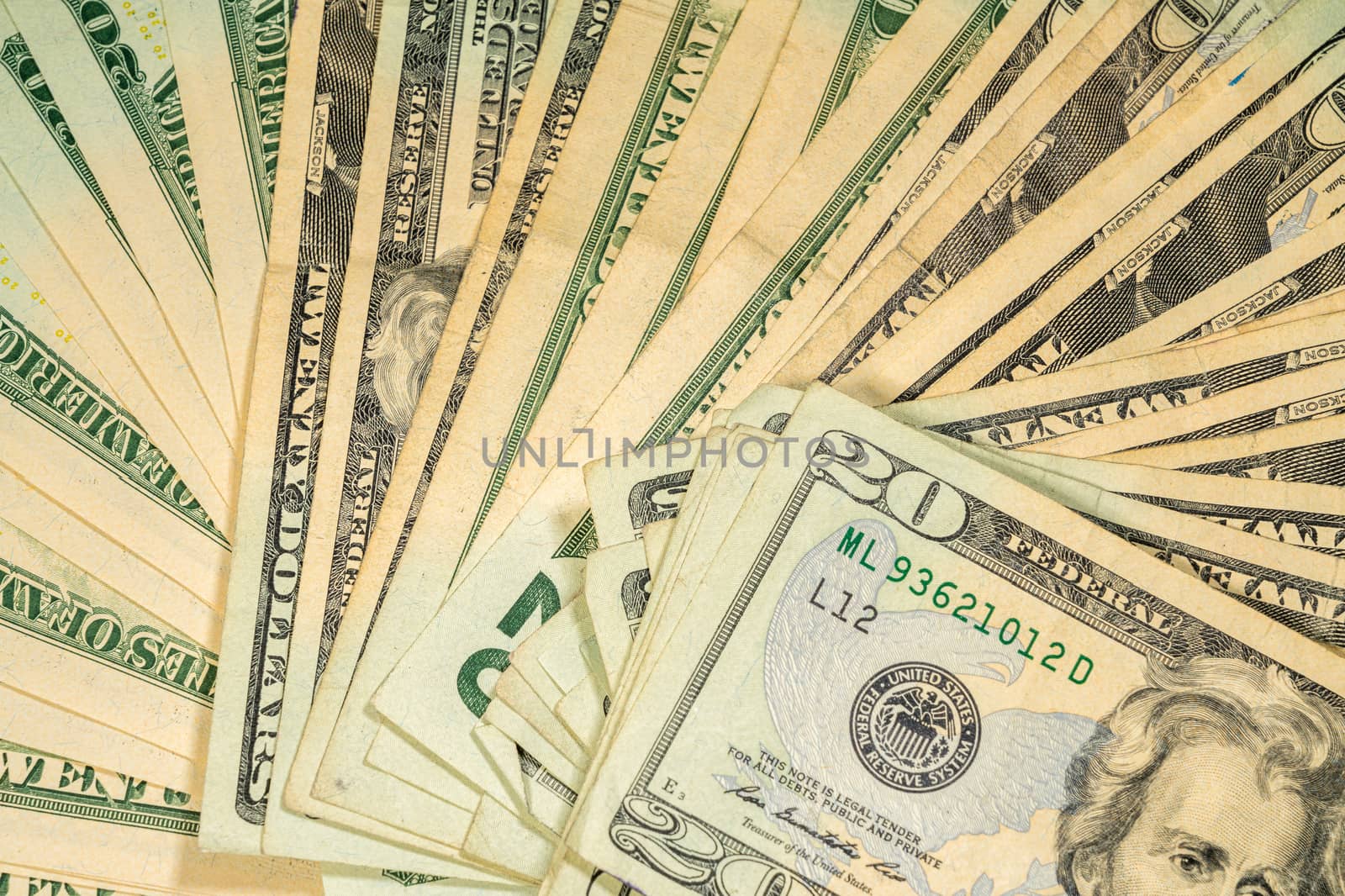 Thousands of US dollars laid out in a fan shape with 20 dollar bills