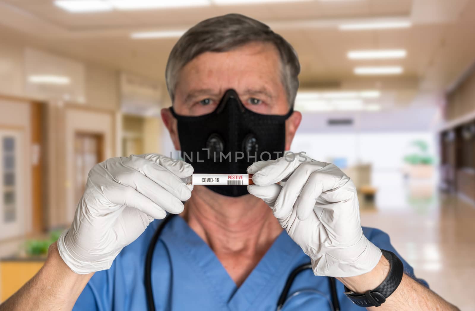 Senior doctor in hospital or clinic wearing protective mask and holding positive test for Covid-19 virus