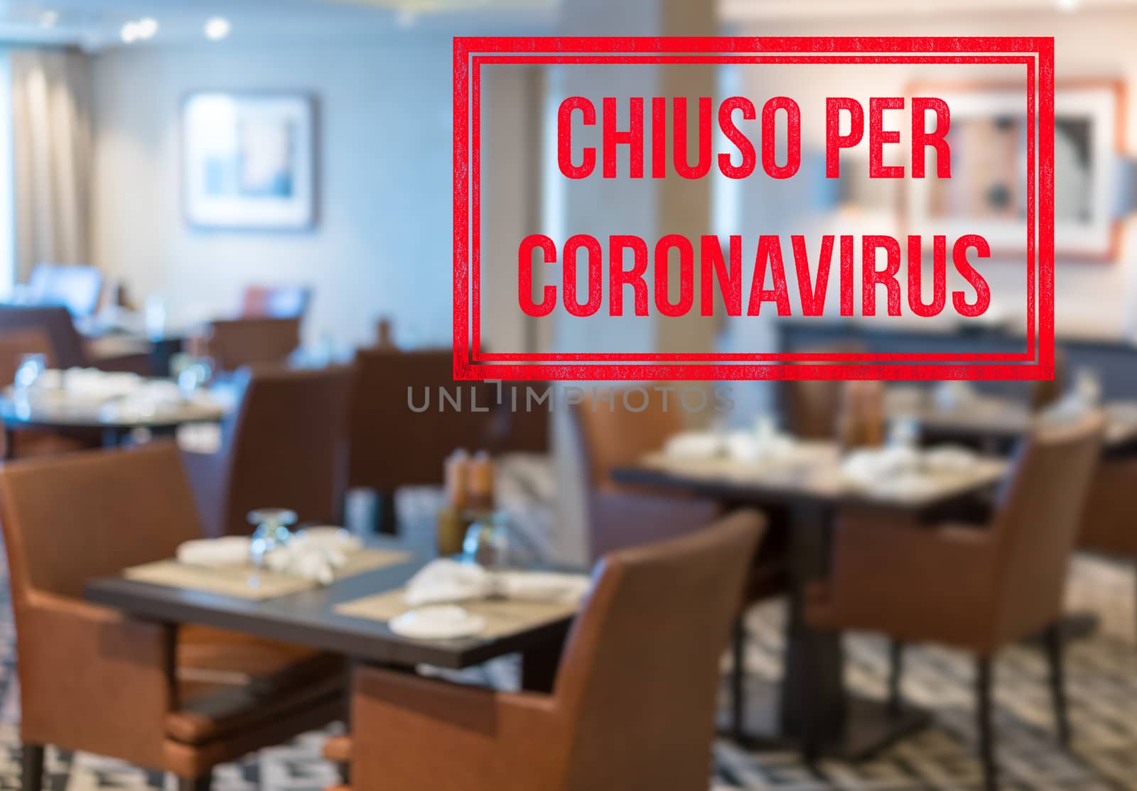 Modern restaurant with tables closed and sign in Italian saying Closed due to Coronavirus by steheap
