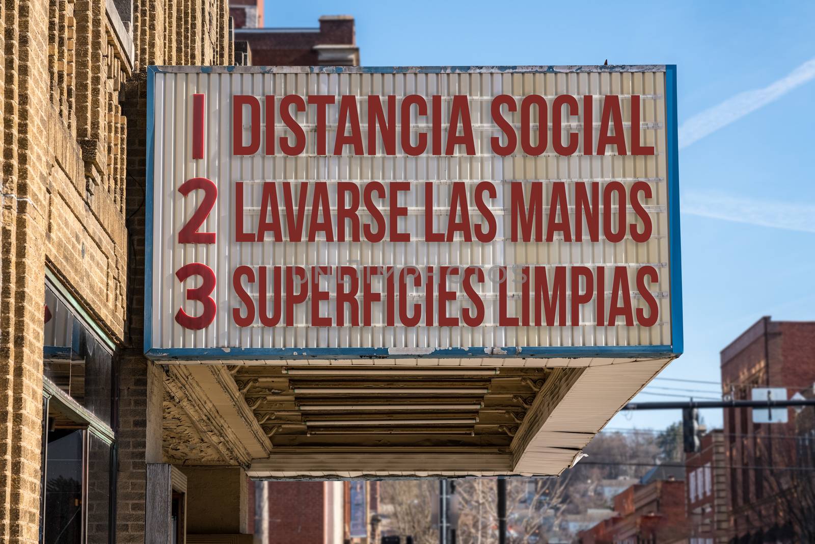 Spanish movie cinema billboard with three rules to avoid the coronavirus epidemic. Translation, wash hands, maintain social distance, clean surfaces
