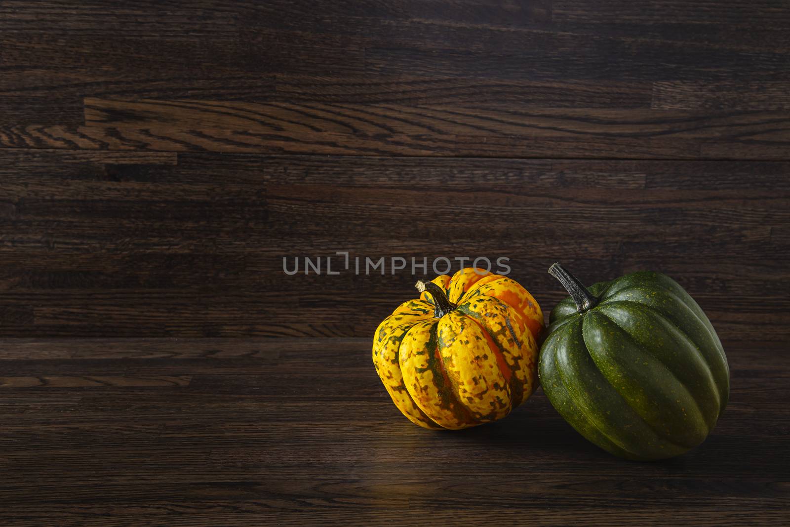 yellow and green sweet dumpling squash against a wood background
