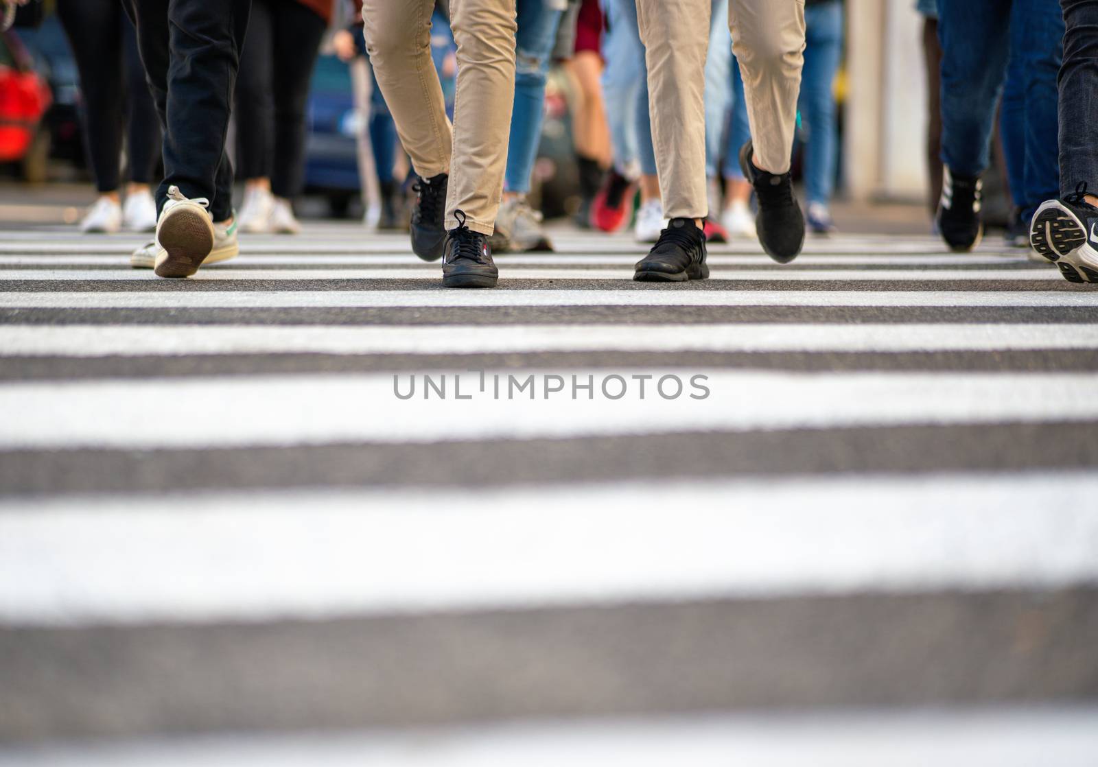 Feet of people walking on pedestrian crossing
