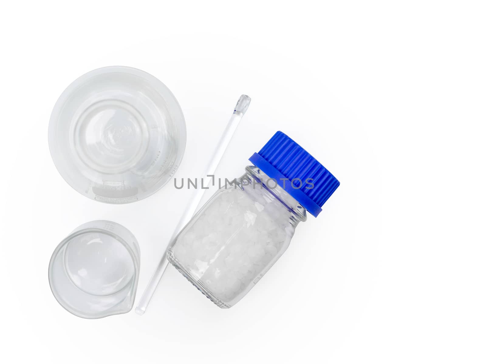 Microcrystalline wax in glass container. Chemical ingredient for Cosmetics & Toiletries product. Stirring Rod, Beaker, Solvent botton, Erlenmeyer flask