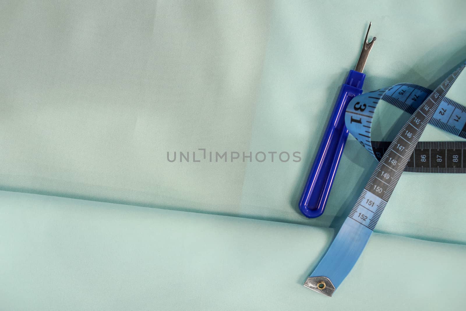 Measuring cables, Thread Picker, Sewing Craft Tool on blue fabric by chadchai_k