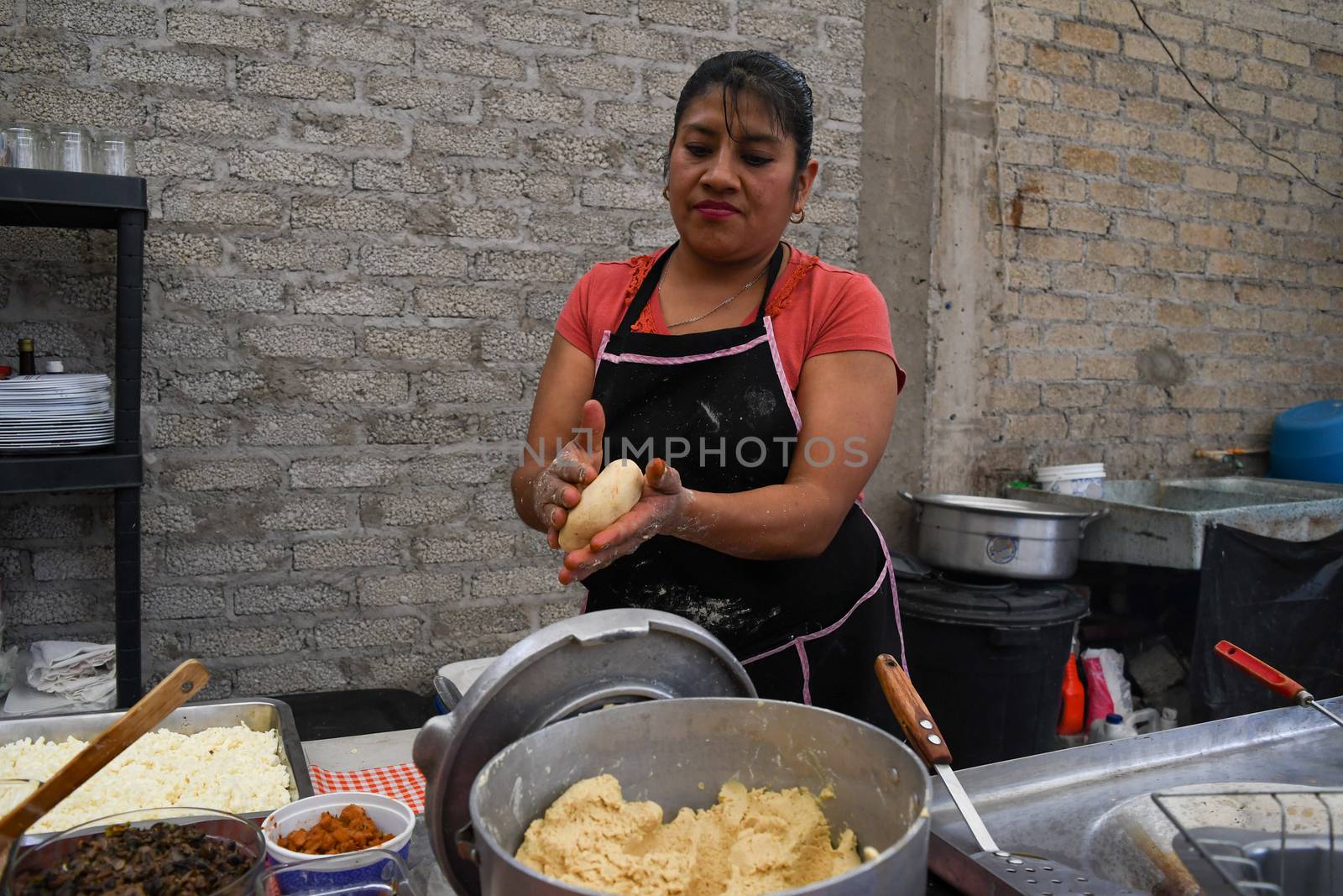 Old woman preparing a typical mexican food with her own hands